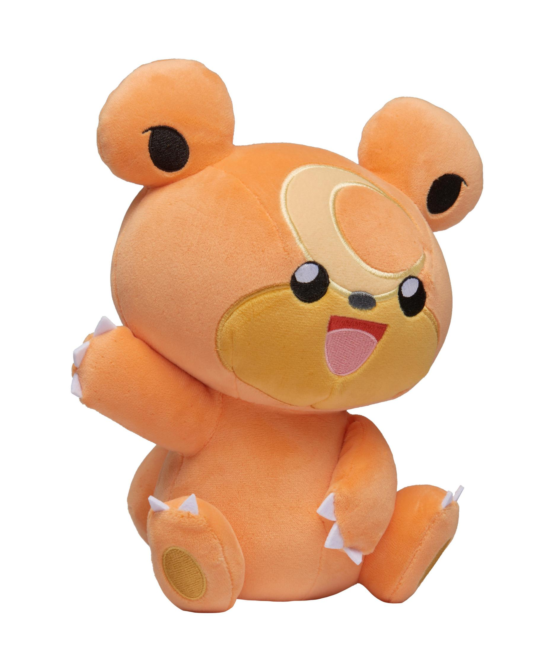 Orangefarbenes Teddybär-Plüschtier. Es hat einen großen Kopf und winkt.