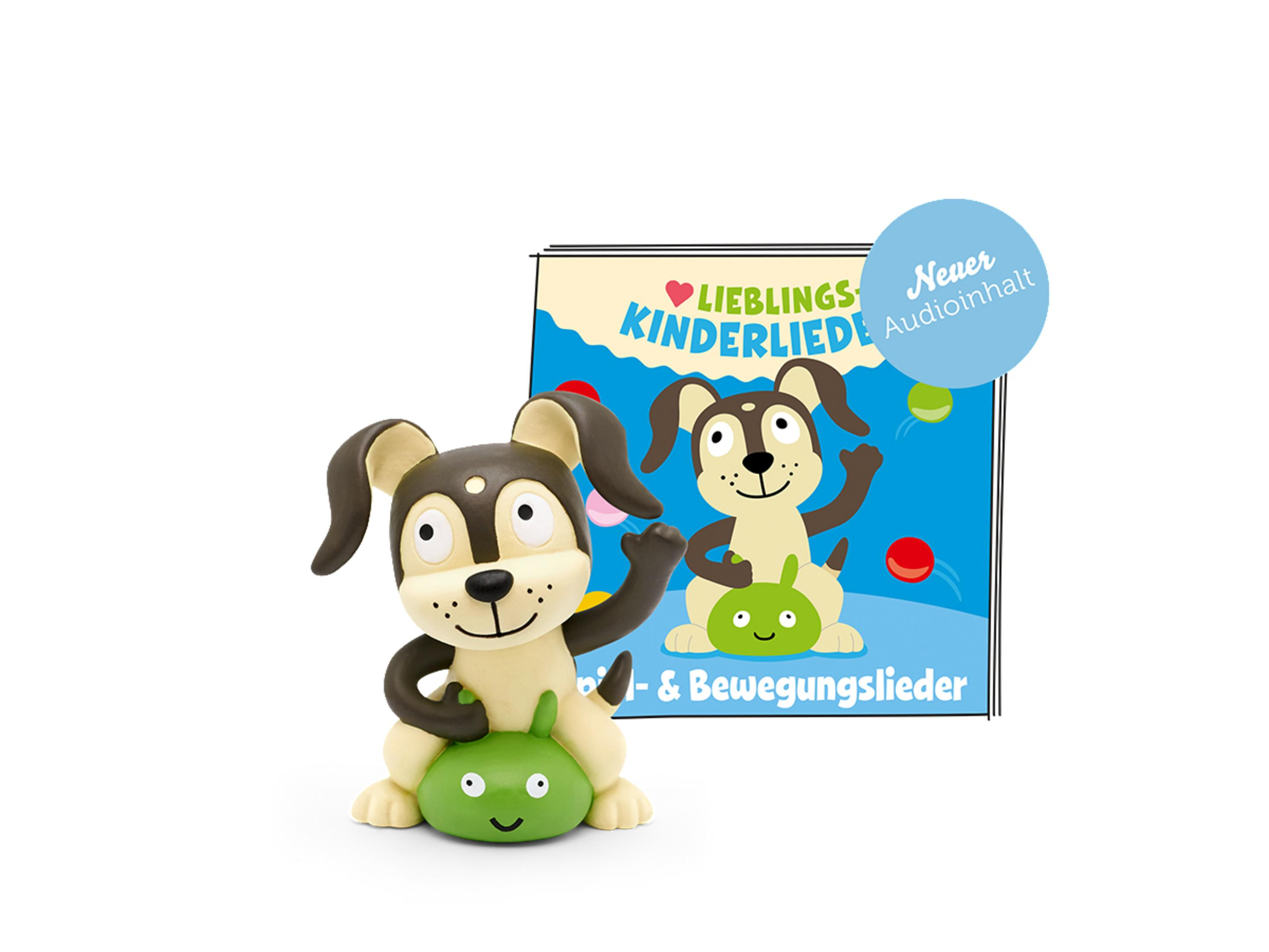 Ein Spielzeughund auf grüner Basis mit einem Buch, Text auf Deutsch. Der Hund ist braun und cremefarben.