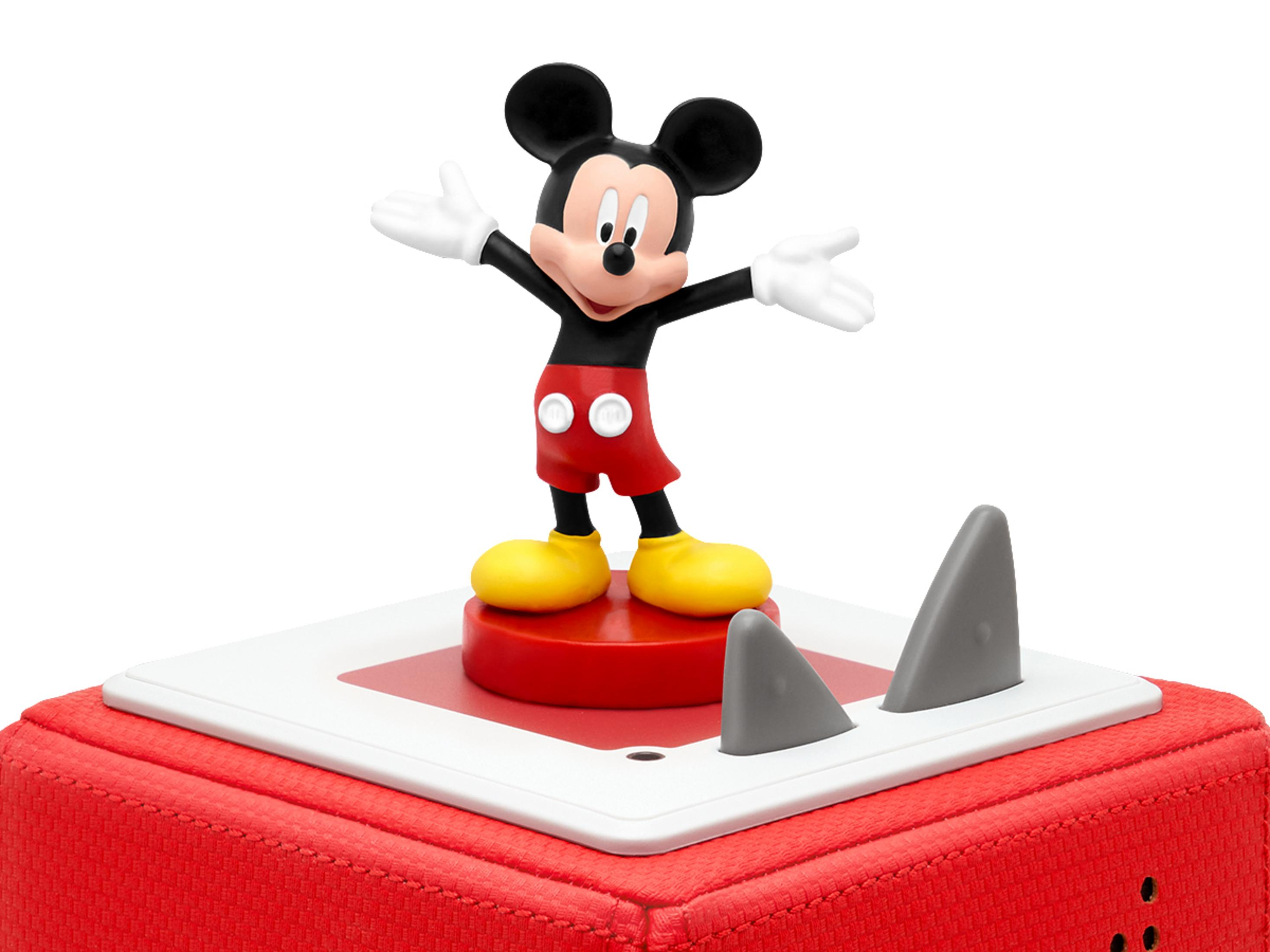 Eine Mickey-Mouse-Figur auf roter Basis. Micky steht mit offenen Armen. Haifischflossen sind auf der Basis.