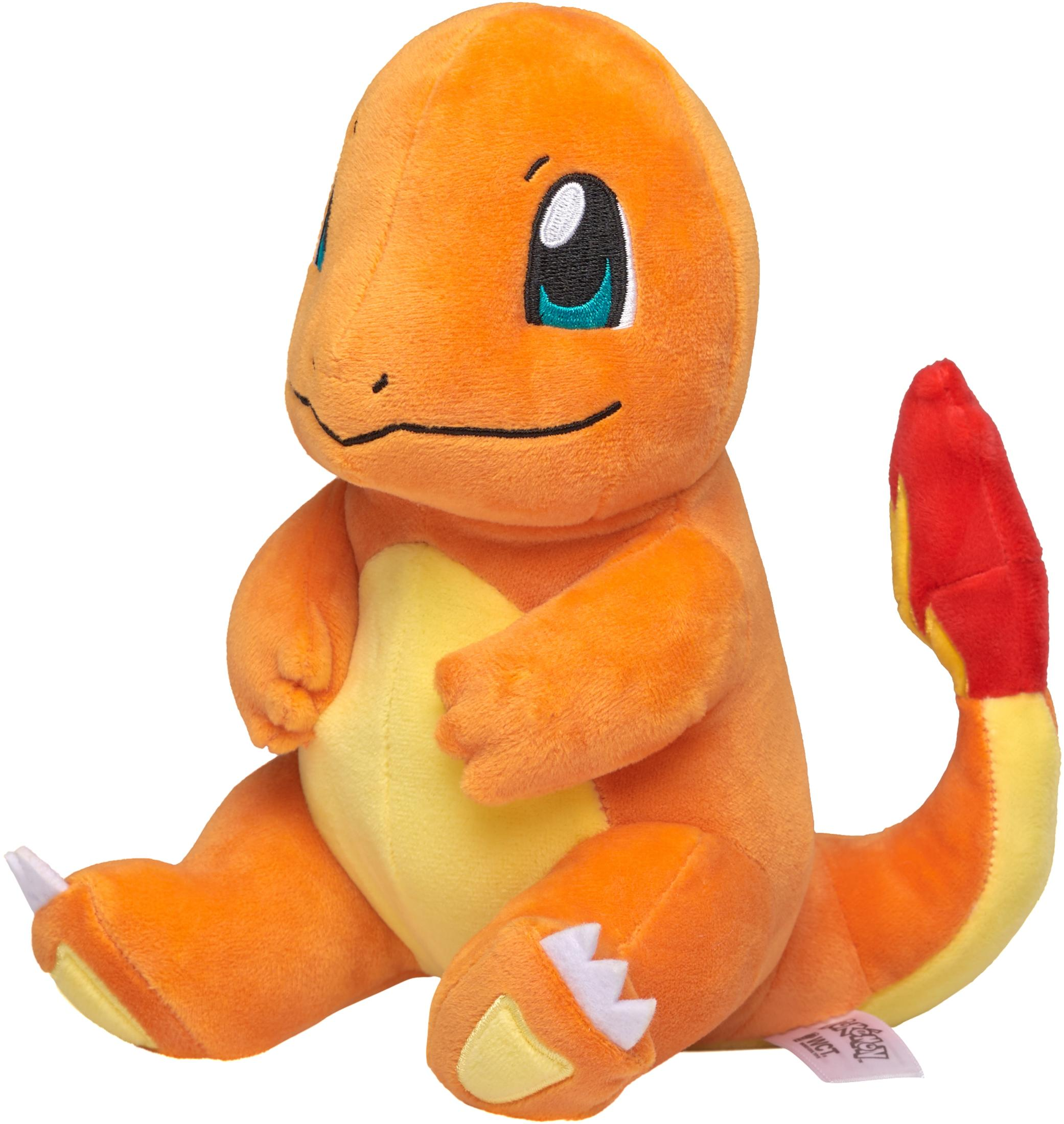 Ein orangefarbenes Charmander-Plüschtier sitzt und blickt nach rechts. Hat weiße Krallen und eine rot-gelbe Flamme.