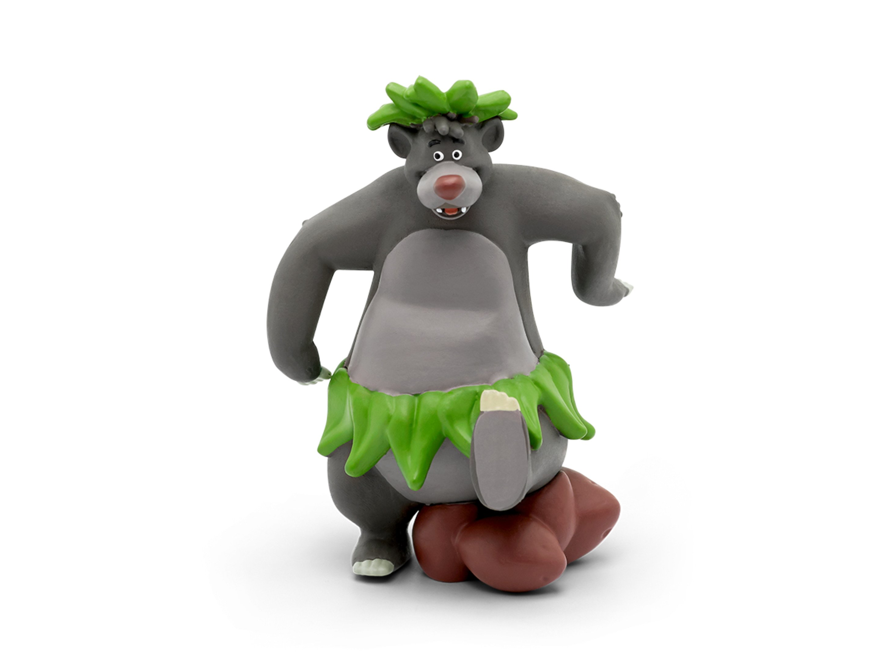 Statuina di Baloo con gonna verde, in piedi su un tronco marrone. Sfondo bianco.