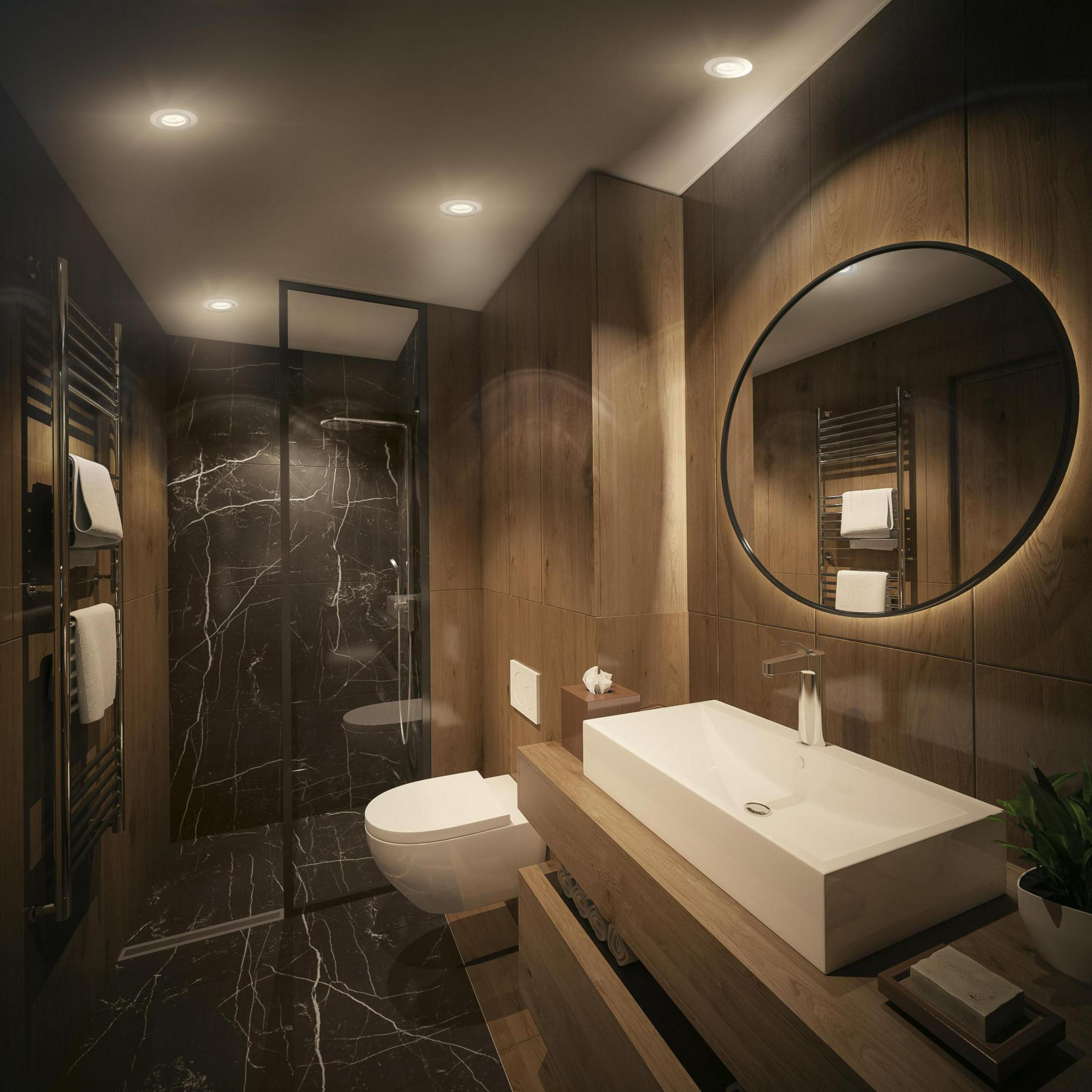 Nowoczesna łazienka z ciemnym marmurem, drewnianymi elementami i okrągłym lustrem.