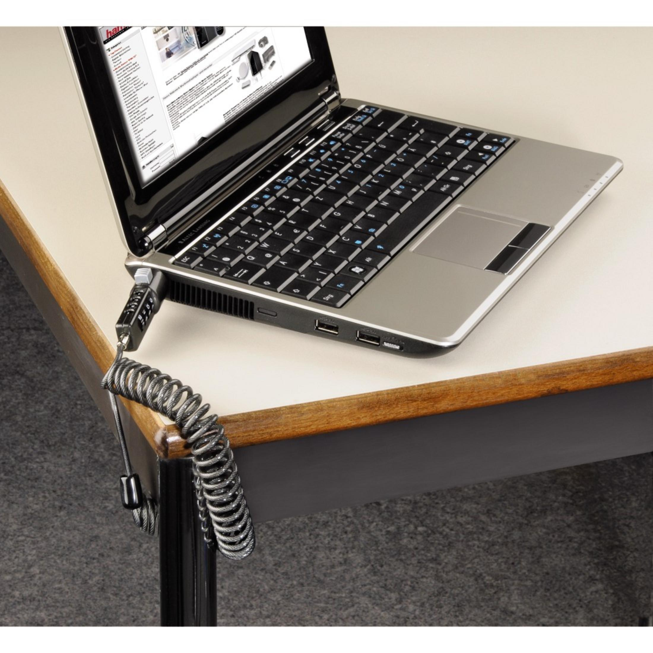 Laptop mit Kabelschloss auf einem Tisch gesichert. Laptop ist geöffnet.