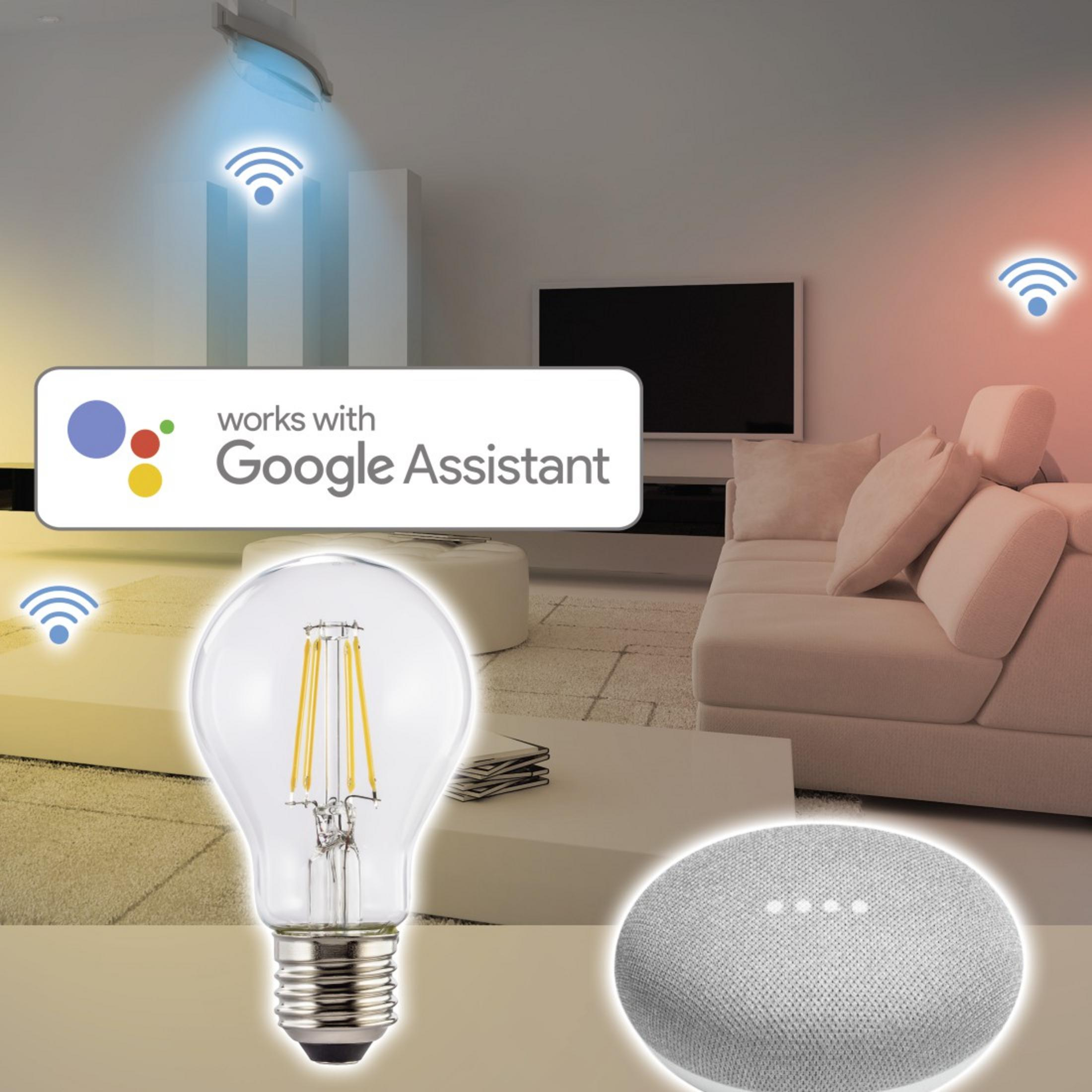 Bombilla y Google Home en una habitación. Muestra señales Wi-Fi y hogar inteligente.