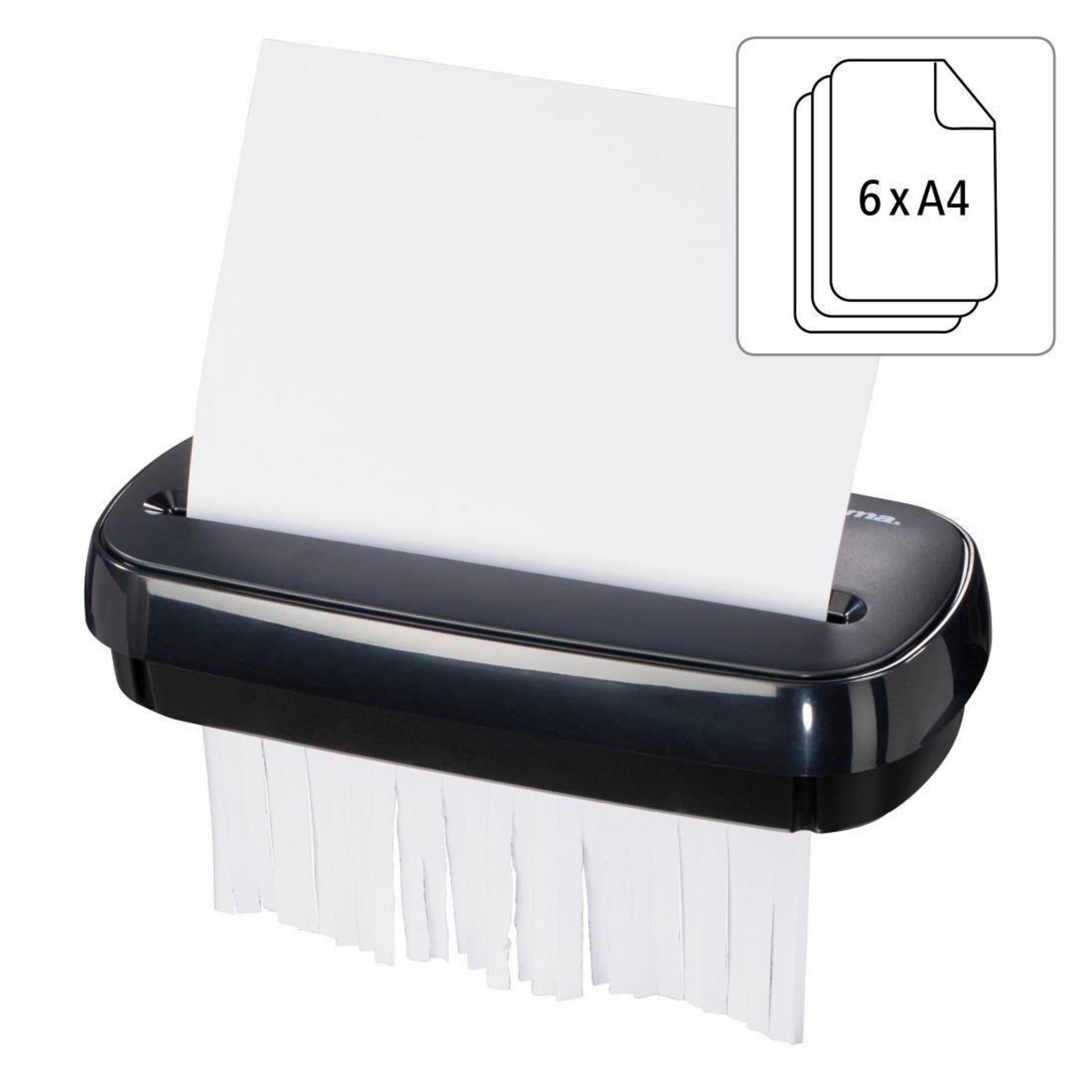 Niszczarka do papieru niszczy papier. Biały papier jest cięty na paski.