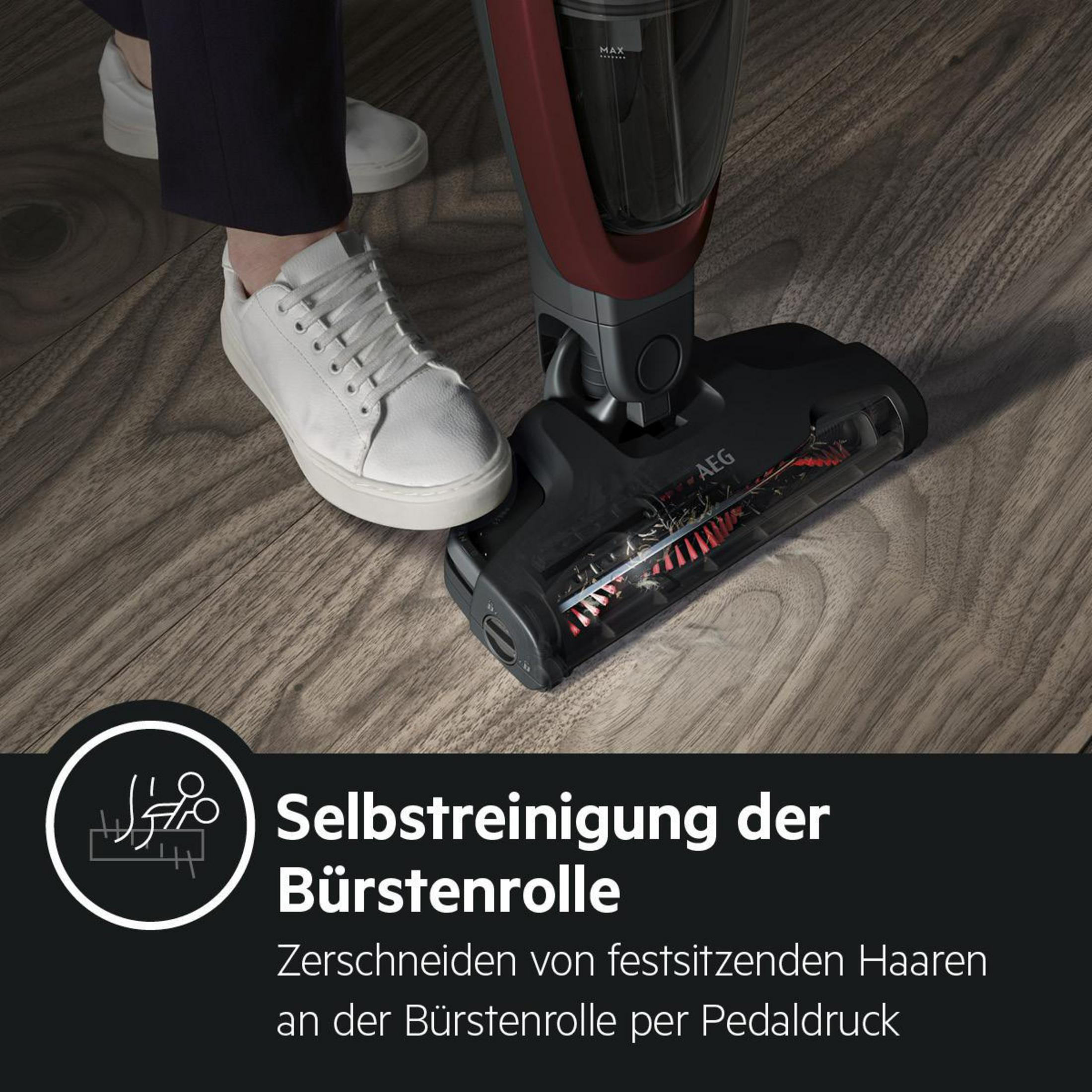 Die Füße einer Person mit weißen Schuhen und ein Staubsaugerkopf auf einem Holzboden.