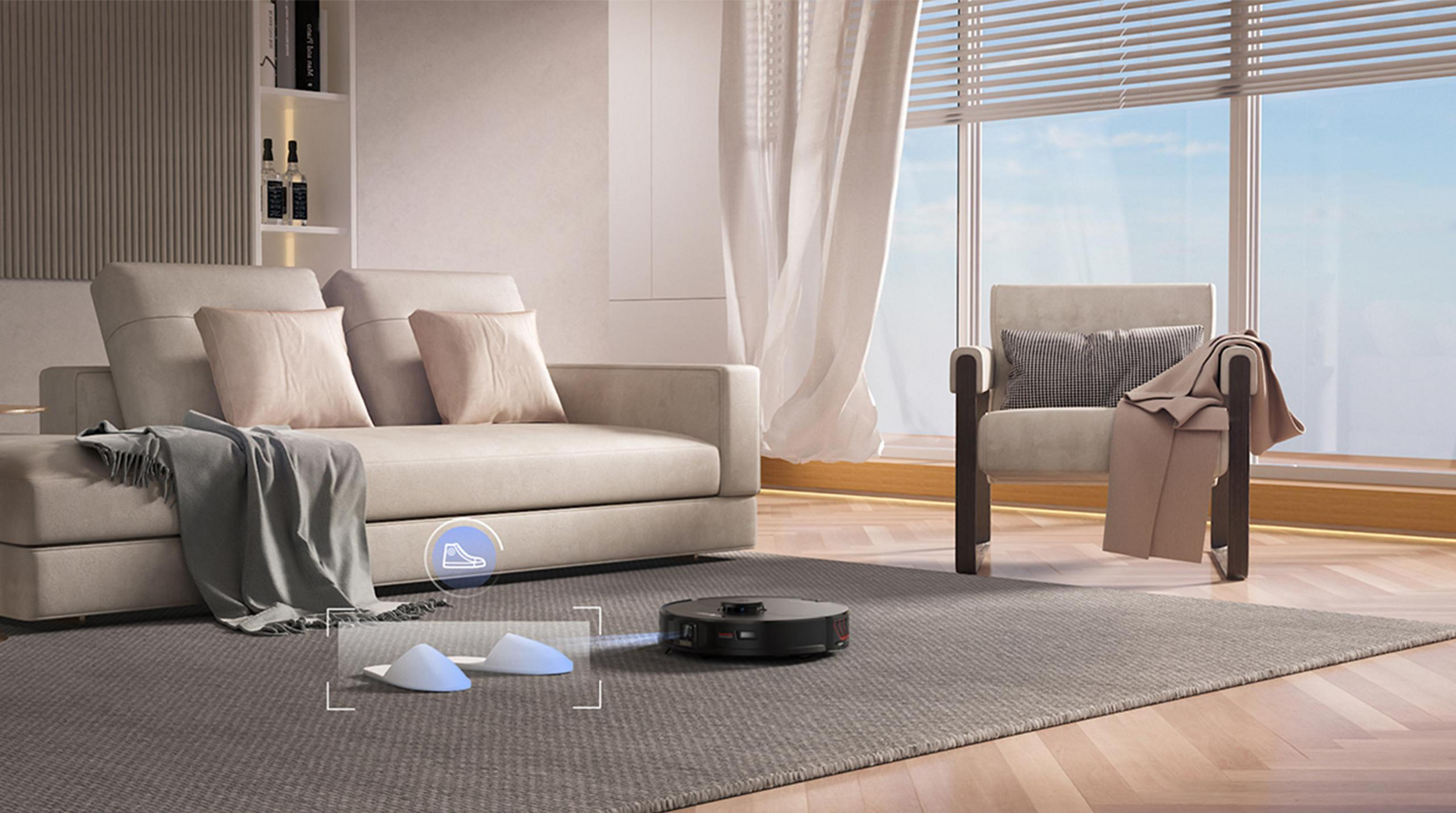 Salon z odkurzaczem automatycznym. Kapcie są podświetlone w pobliżu odkurzacza.