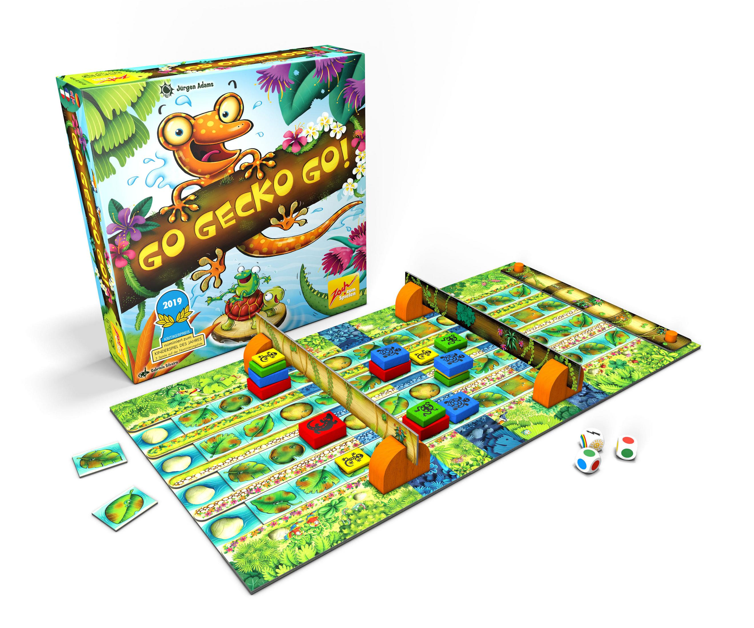 Spielbox mit einem Gecko auf einem Baumstamm. Das Spielbrett hat ein farbenfrohes Design und Würfel.