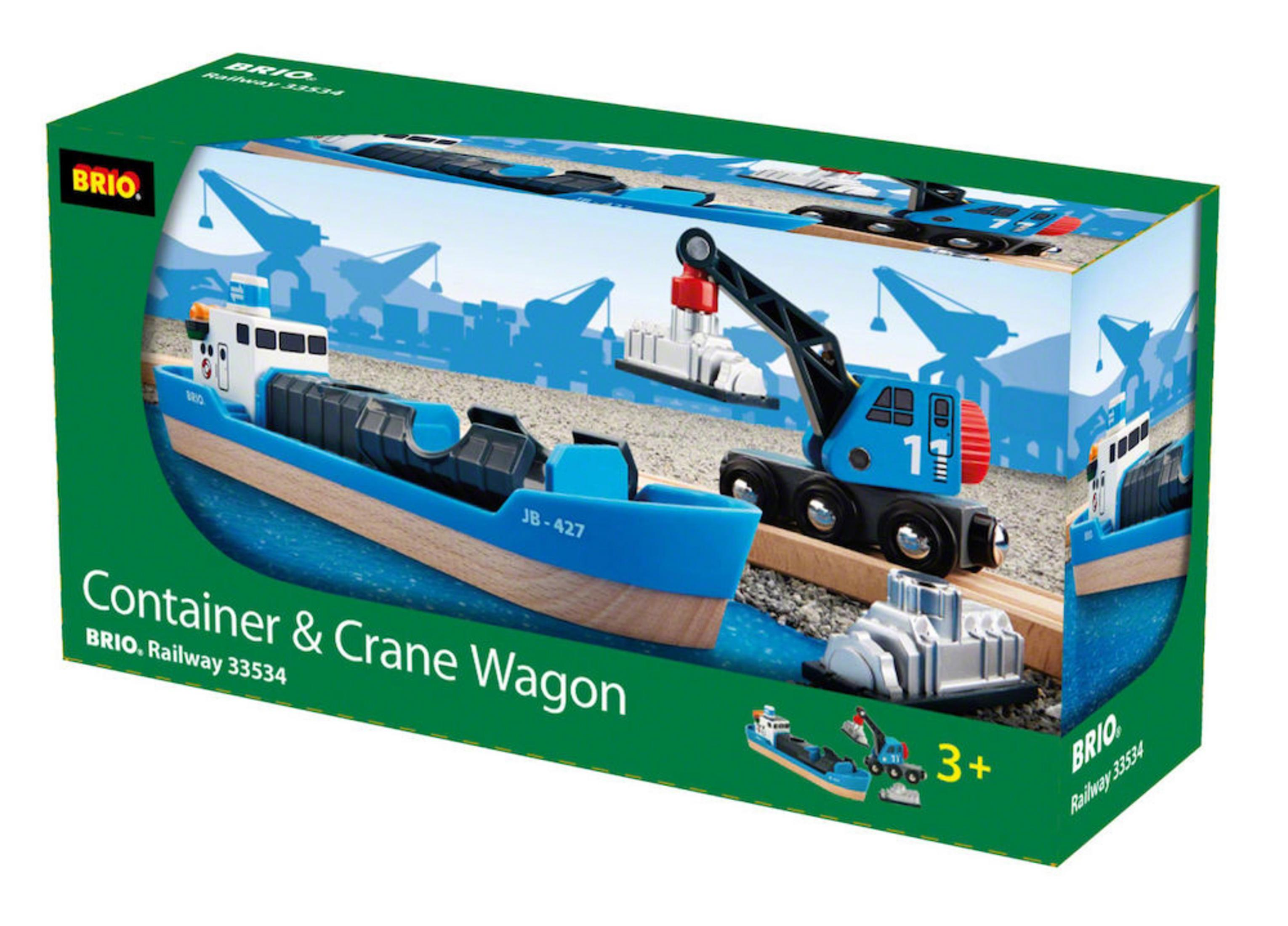 Schachtel mit Spielzeugboot, Kran und Container auf blauem Untergrund.