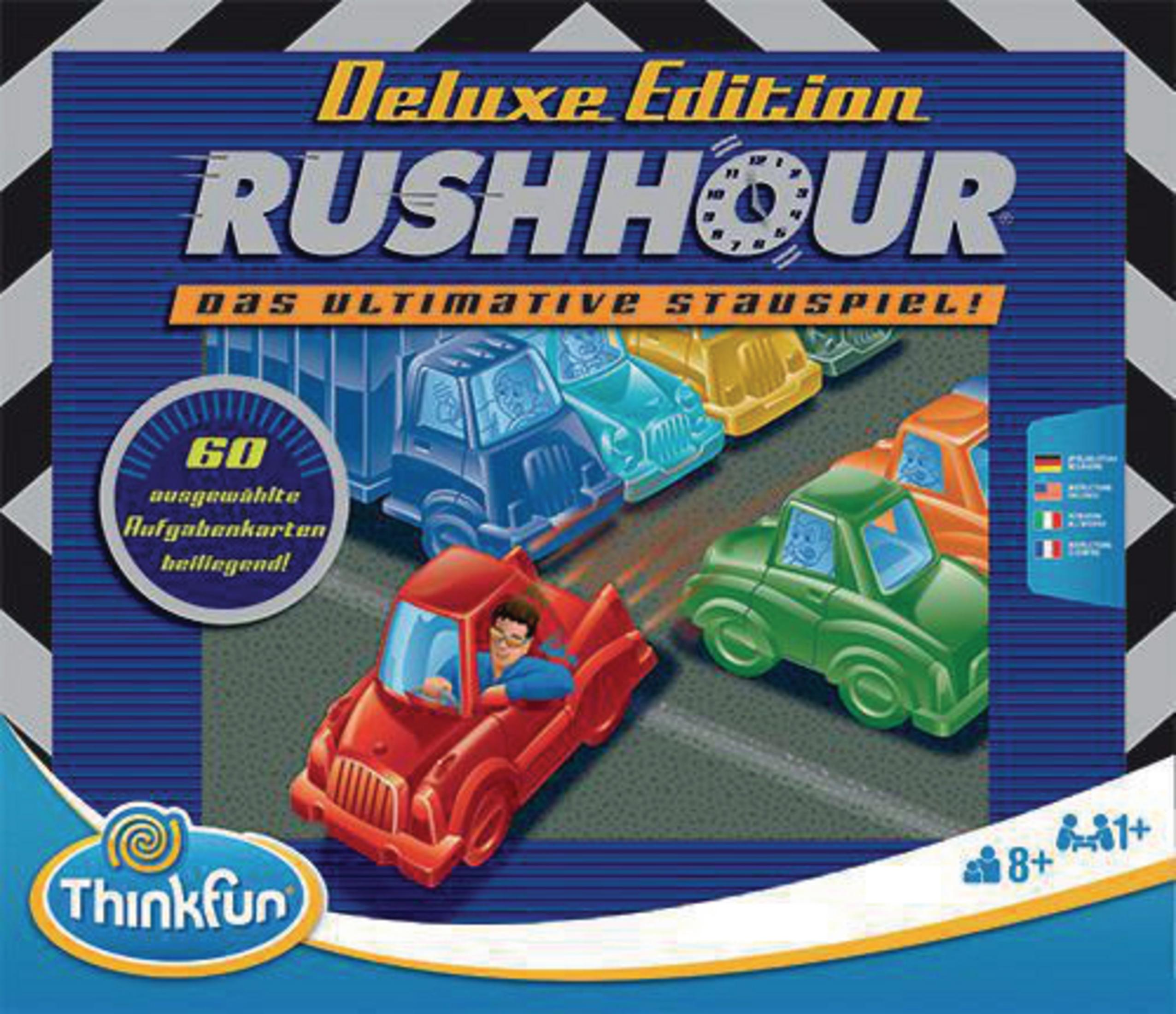 Verpacktes Brettspiel mit Spielzeugautos auf einer Rennstrecke. Text sagt 'Rush Hour' und 'Deluxe Edition'.