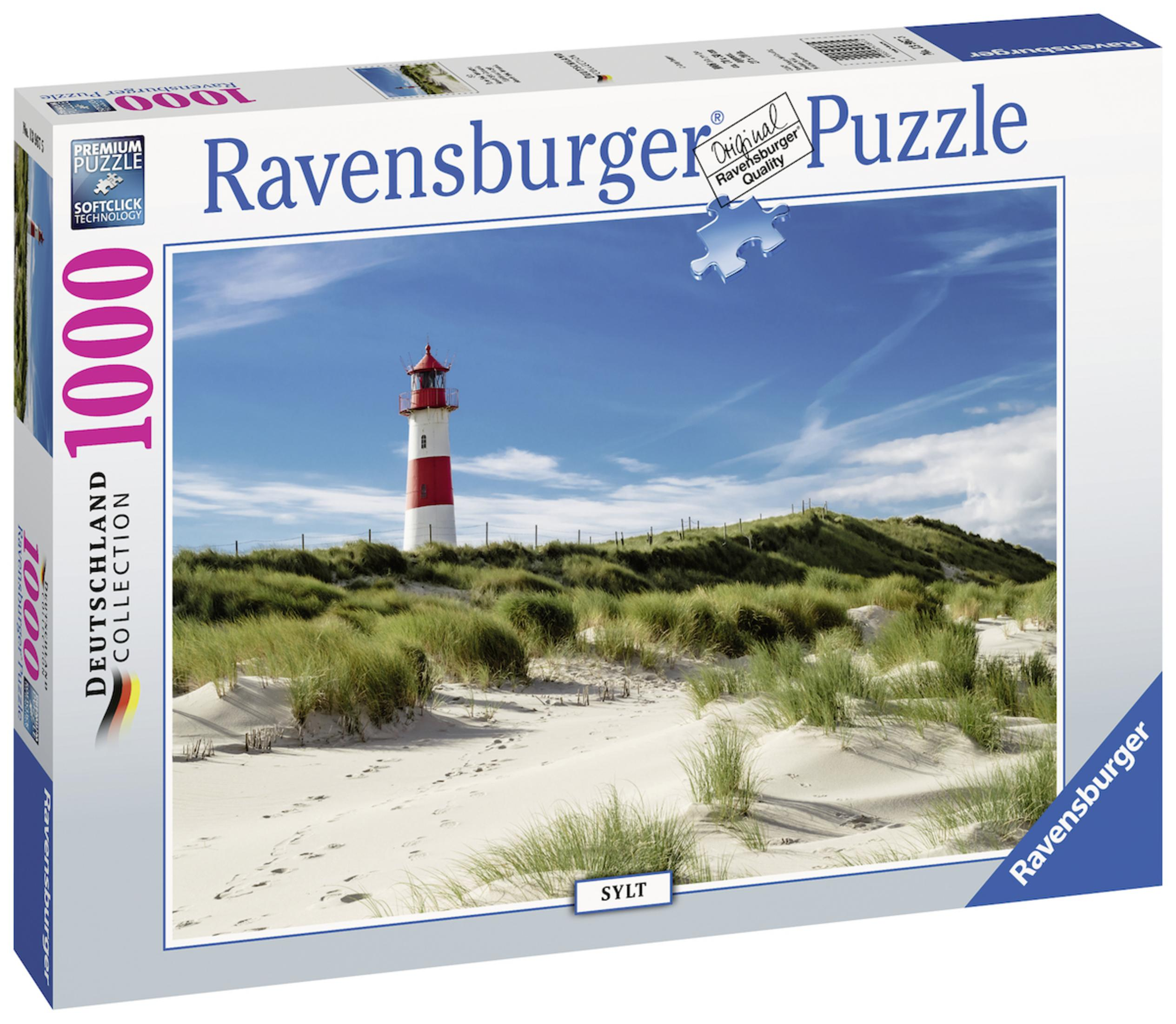 Scatola del puzzle con un faro su una spiaggia sabbiosa e cielo blu con nuvole.