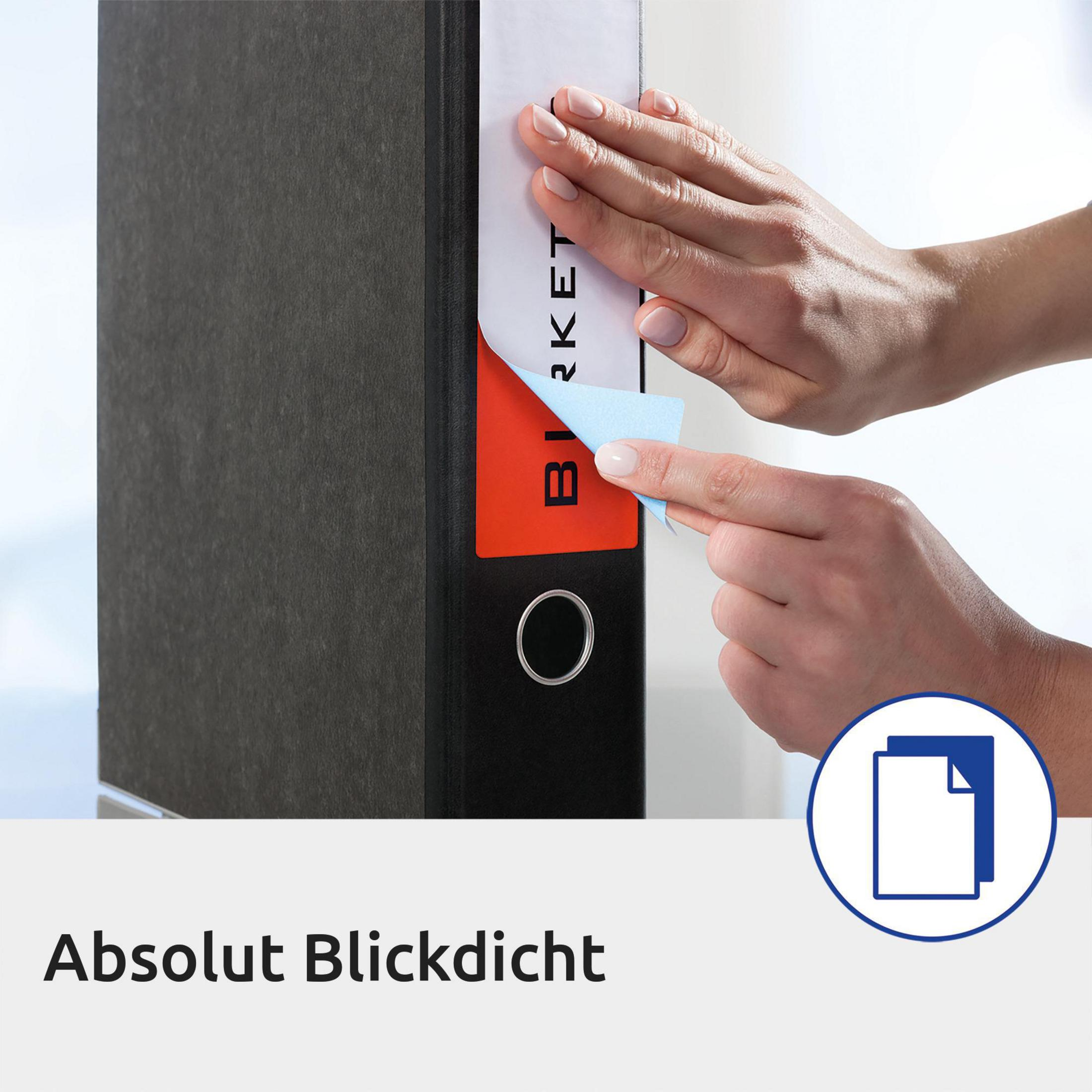 Eine Person, die ein Etikett auf einen schwarzen Ordner klebt. Ein blauer Aufkleber ist sichtbar.