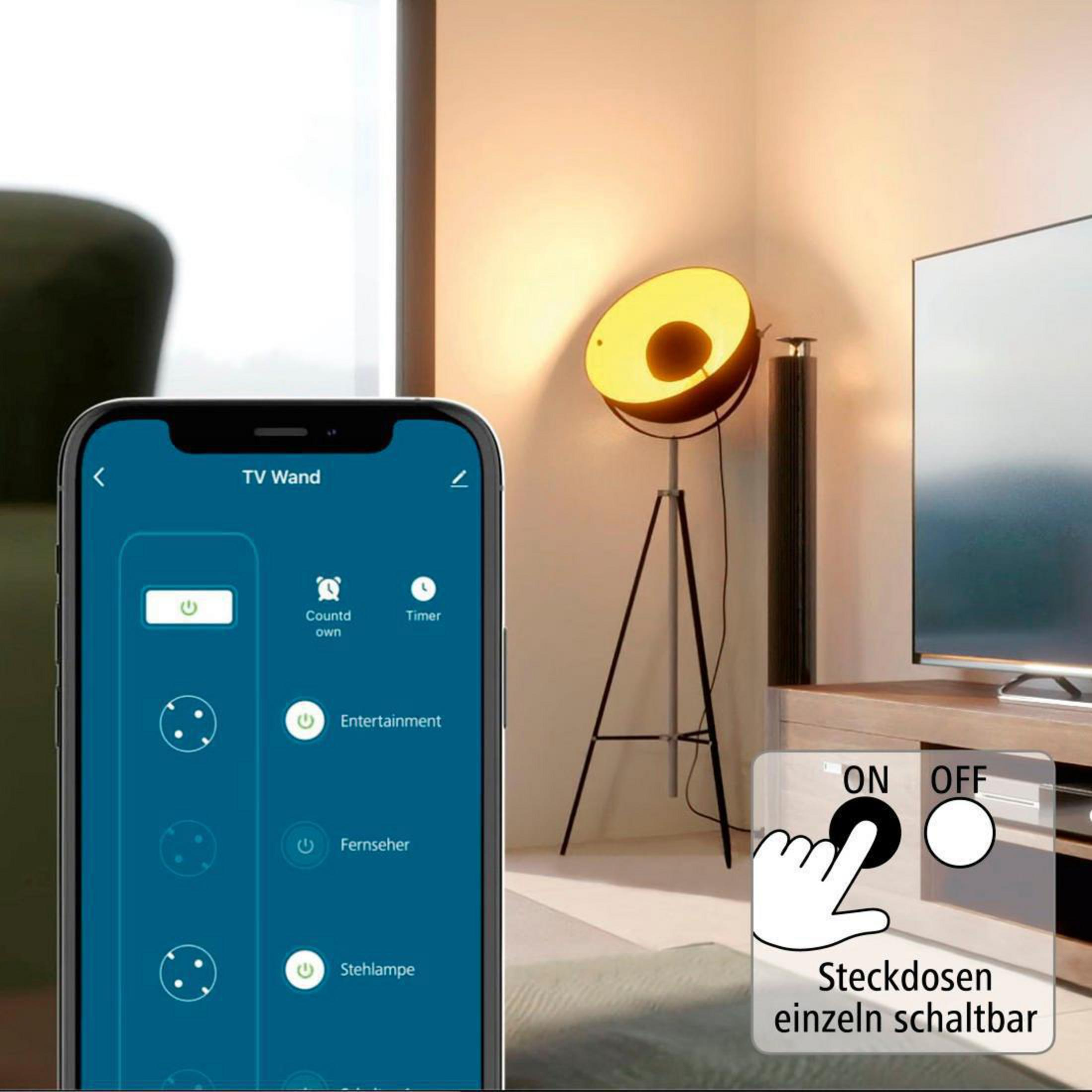 Eine Hand schaltet eine Lampe über eine Telefon-App ein, mit Stehlampe im Hintergrund.