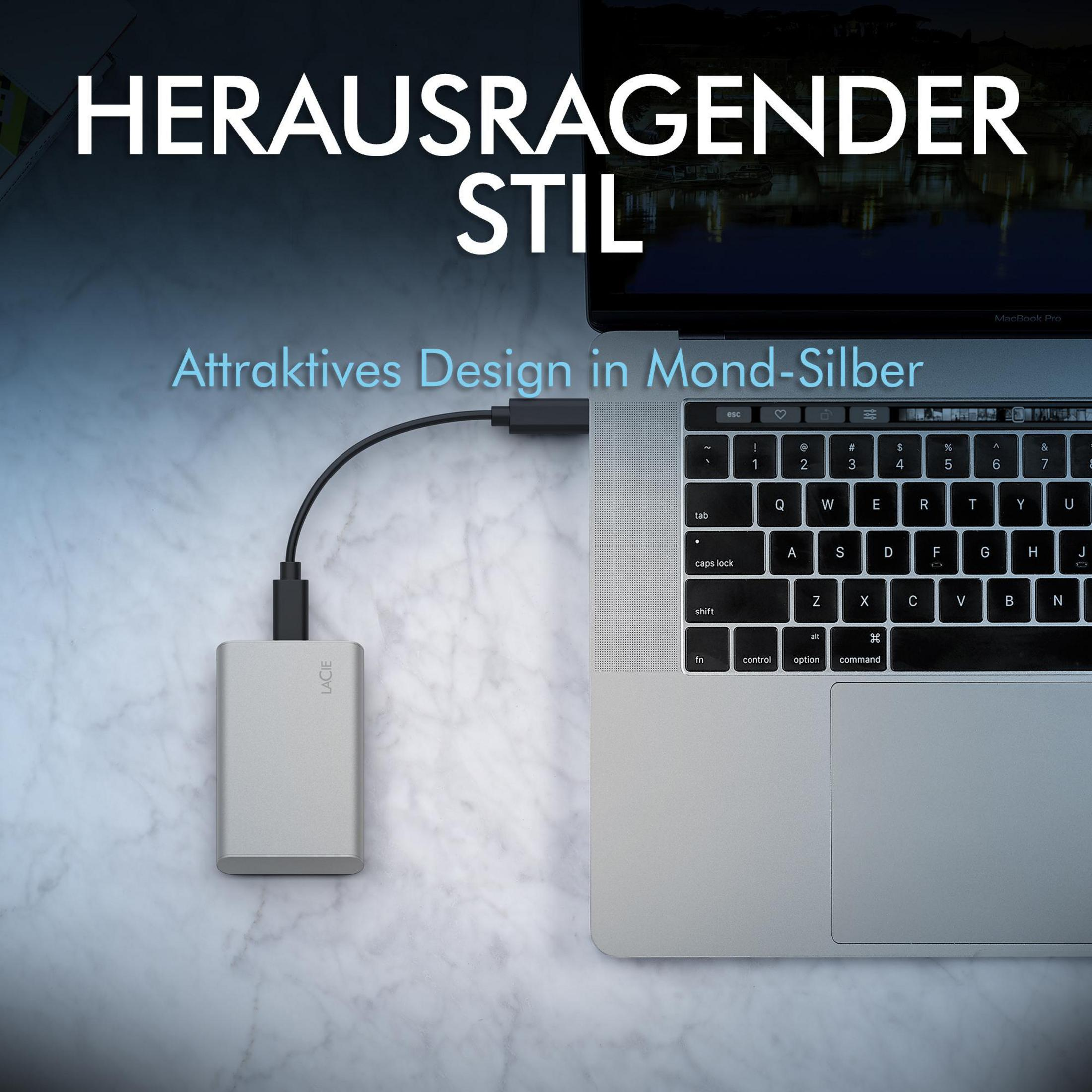 Eine silberne externe Festplatte, die mit einem Laptop verbunden ist.