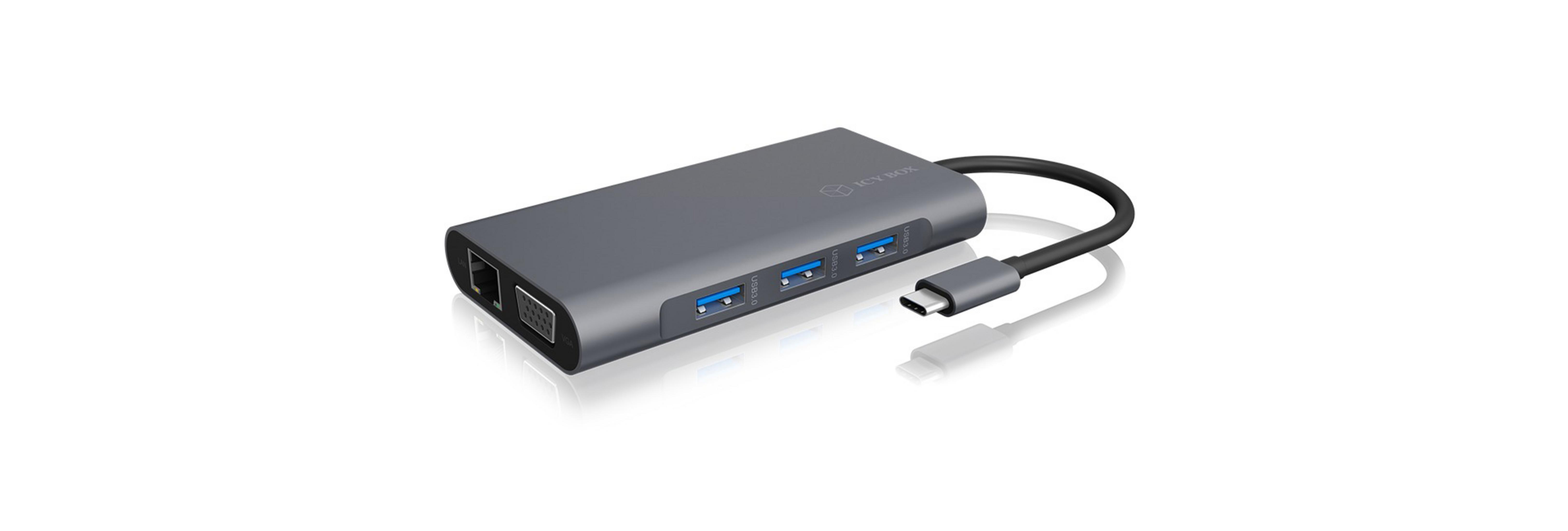 Hub USB grigio con più porte e cavo, isolato su sfondo bianco.