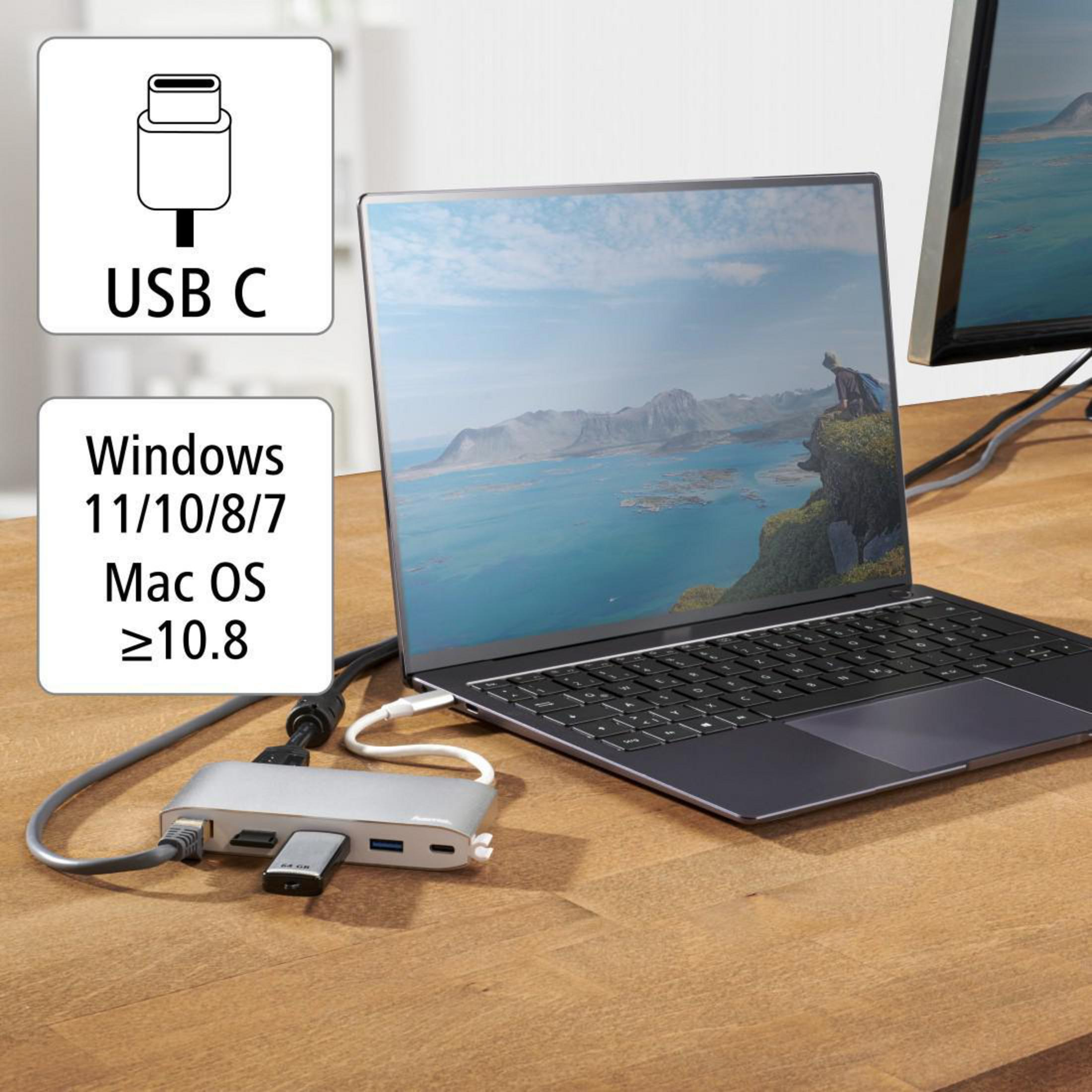 Laptop mit Hub verbunden, zeigt USB-C, Windows/Mac OS und andere Anschlüsse auf einem Holztisch.