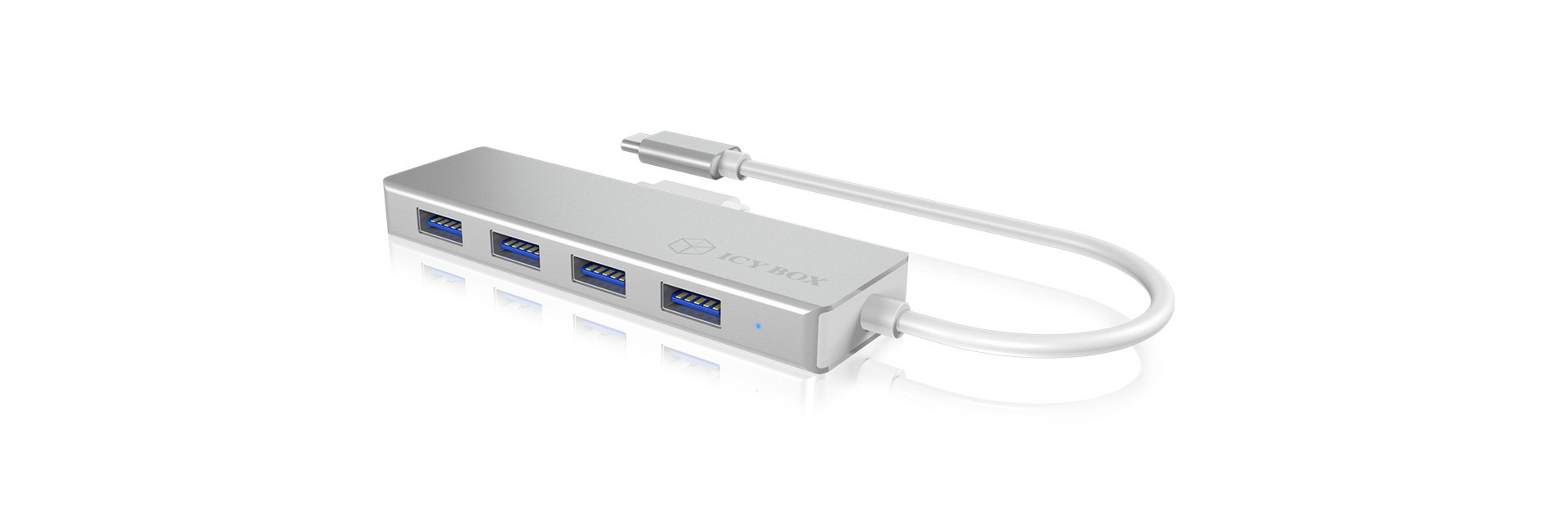Hub USB argenté avec quatre ports USB, connecté à un câble blanc.