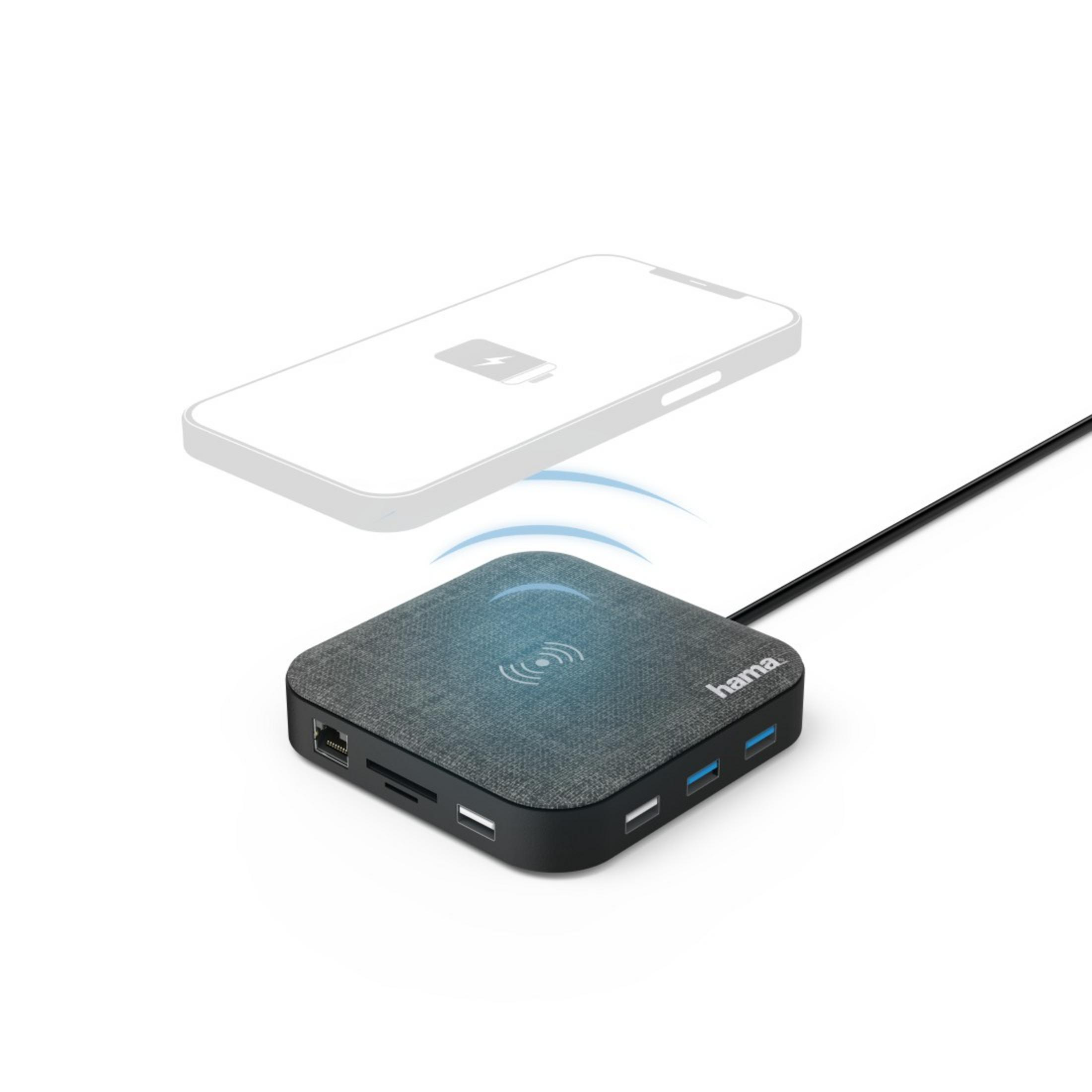 Un hub Hama grigio con più porte, un'area di ricarica wireless e un telefono.