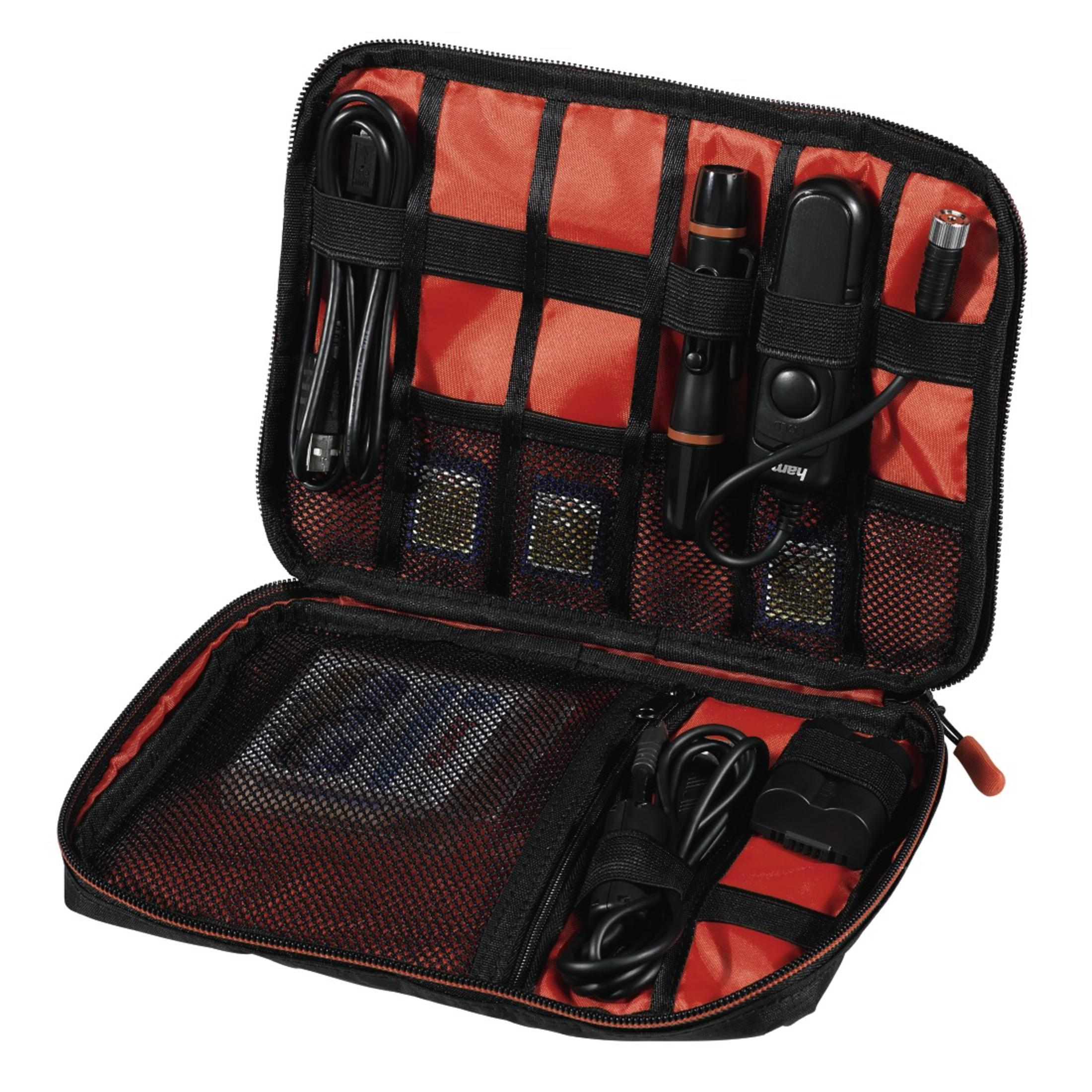 Offene schwarze Tasche mit verschiedenen elektronischen Zubehörteilen, einschließlich Kabeln.