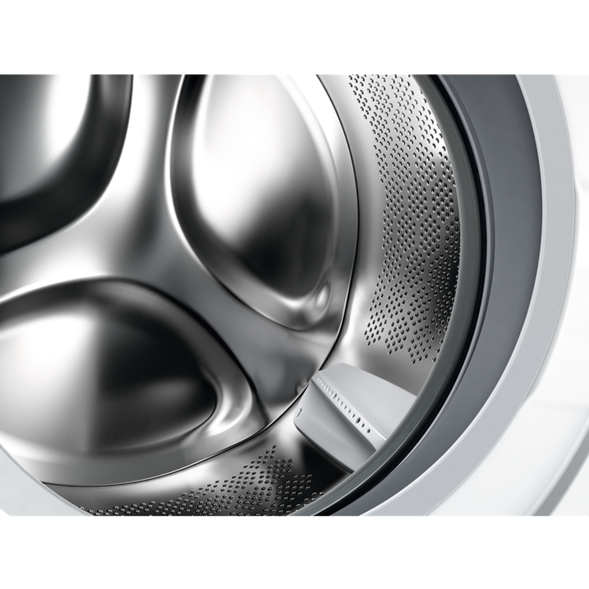 Wnętrze bębna pralki. Jest ze stali nierdzewnej i ma otwory. W środku znajduje się biały element.