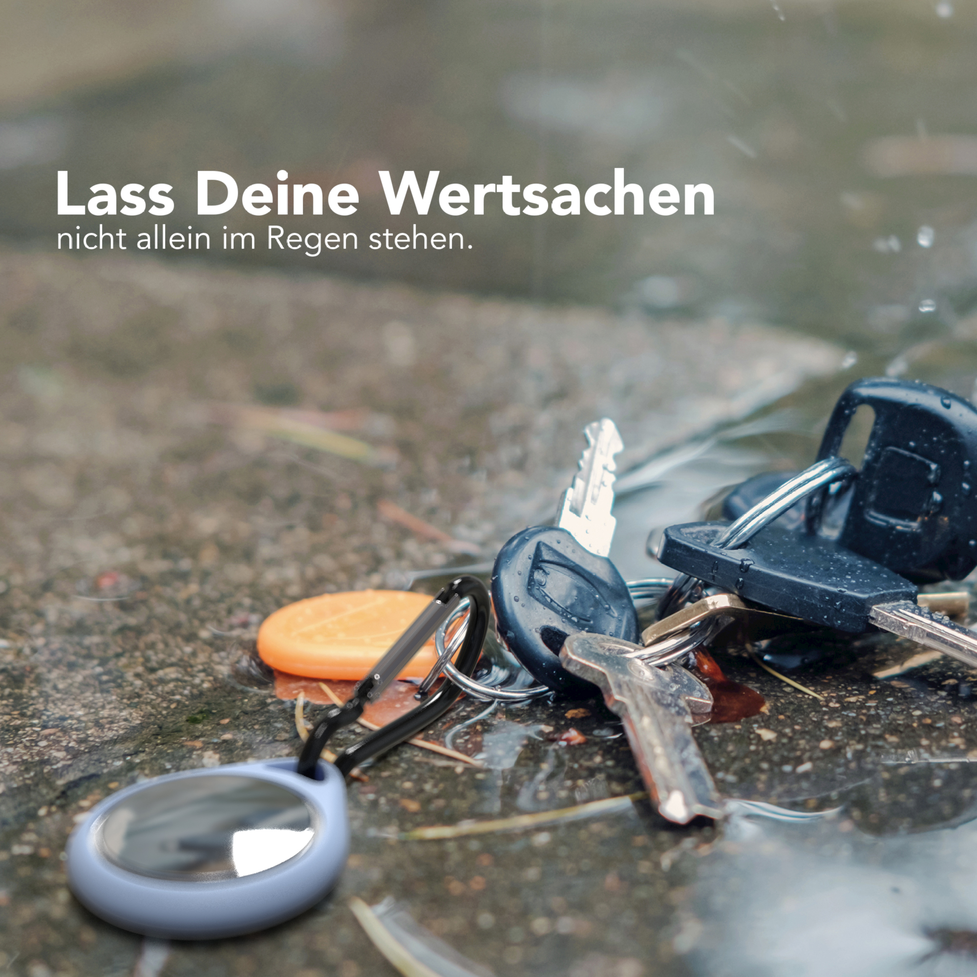 Schlüssel auf nassem Pflaster. Text auf Deutsch oben, 