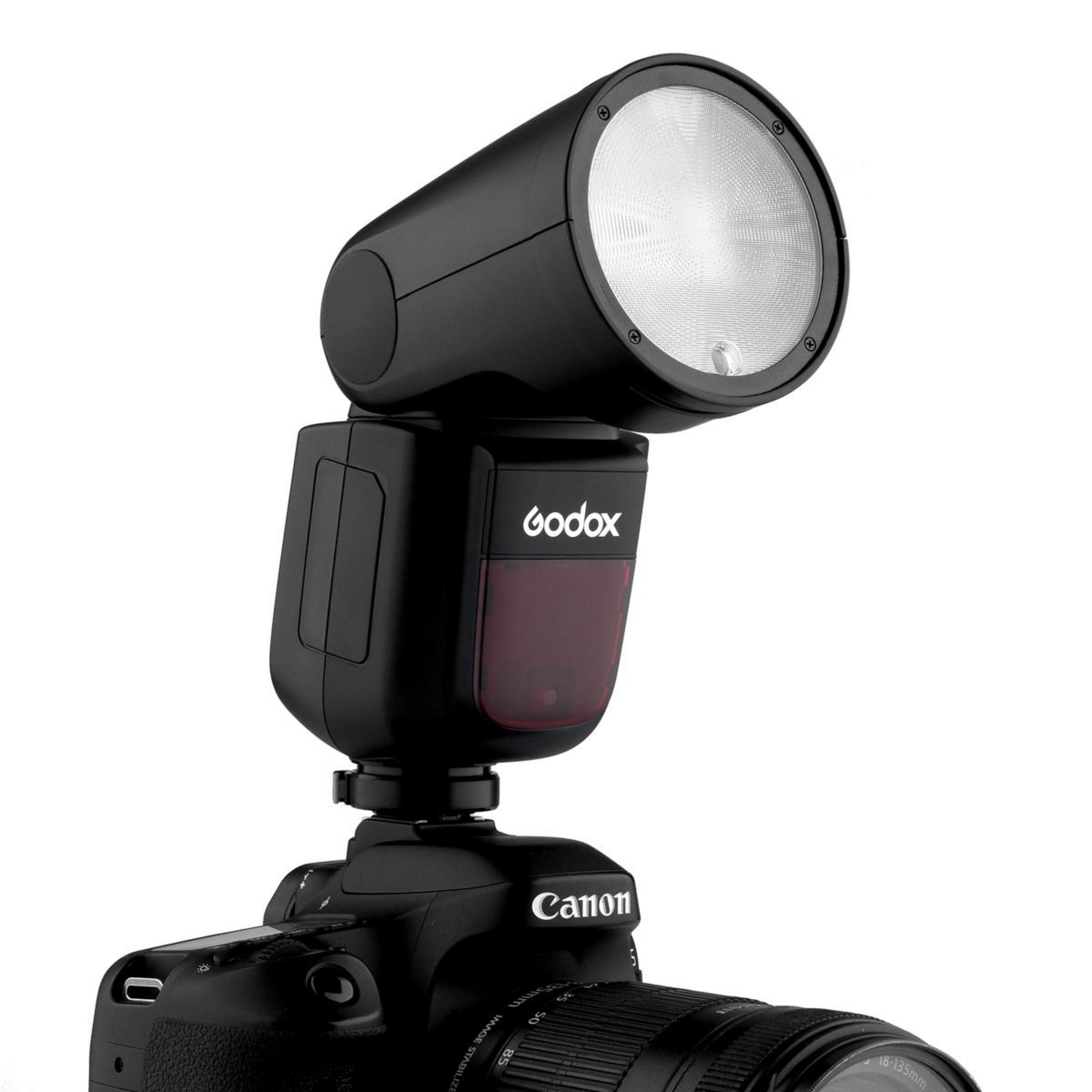 Schwarzer Blitz auf Canon DSLR, Godox-Marke sichtbar.