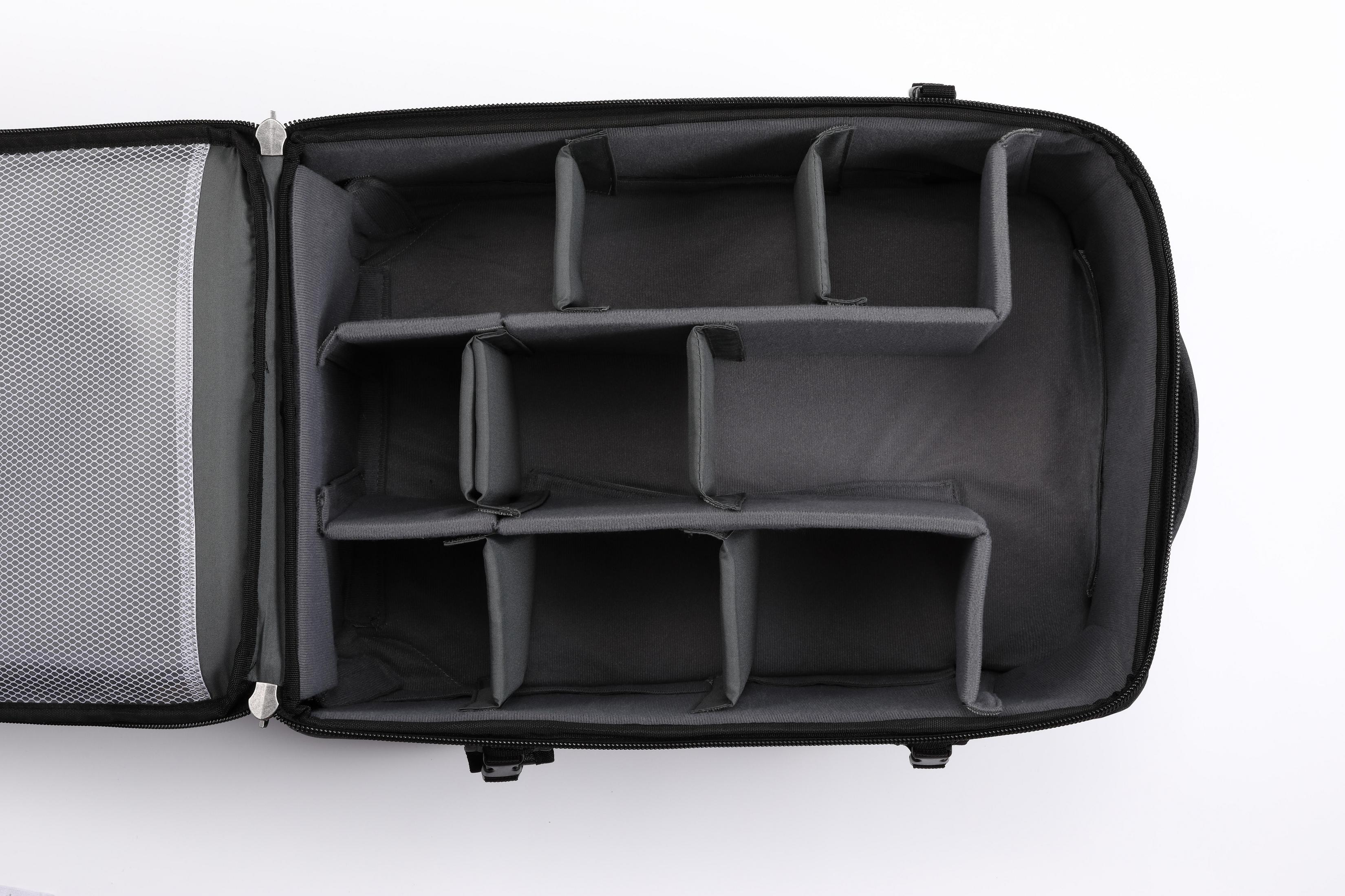 Eine offene Kameratasche mit Trennwänden wird gezeigt. Der Innenraum ist grau, mit einer Netztasche links.