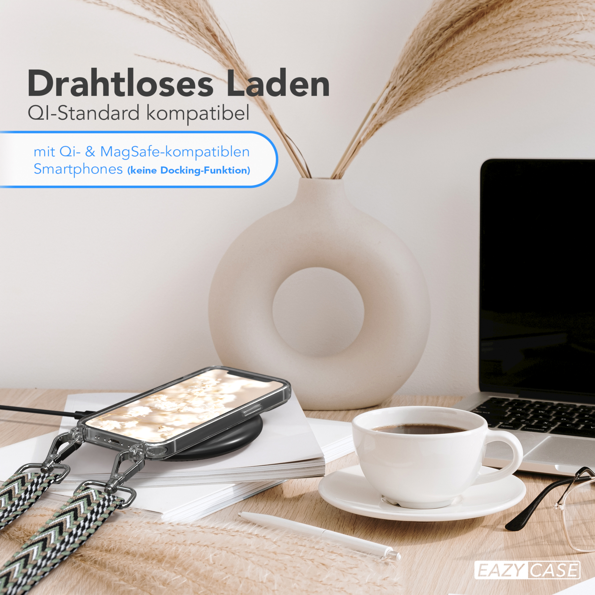 Ein Telefon auf einem kabellosen Ladegerät, mit Kaffeetasse und Dekorationen.