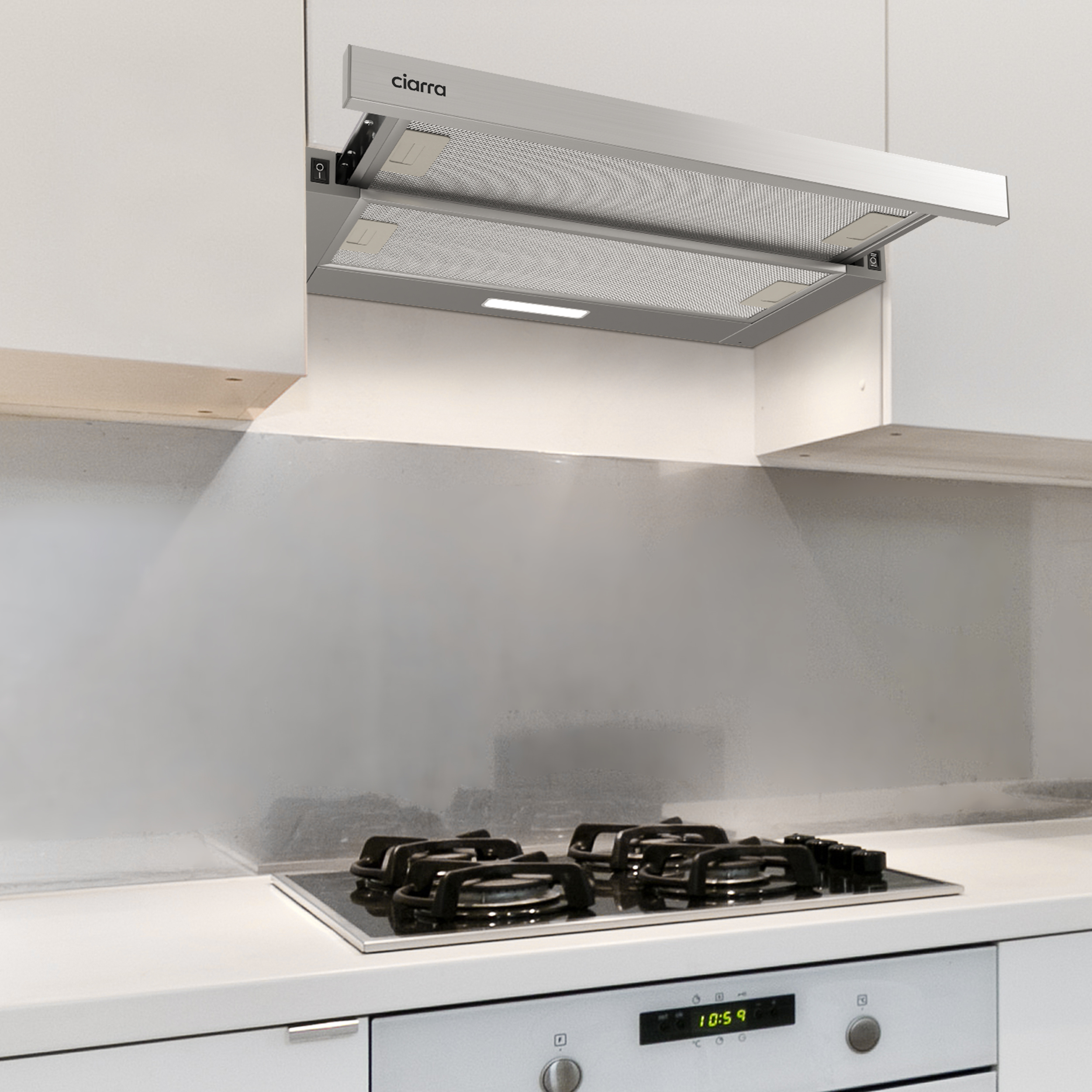 A silver range hood above a cooktop. The hood is open, and the cooktop is black.
