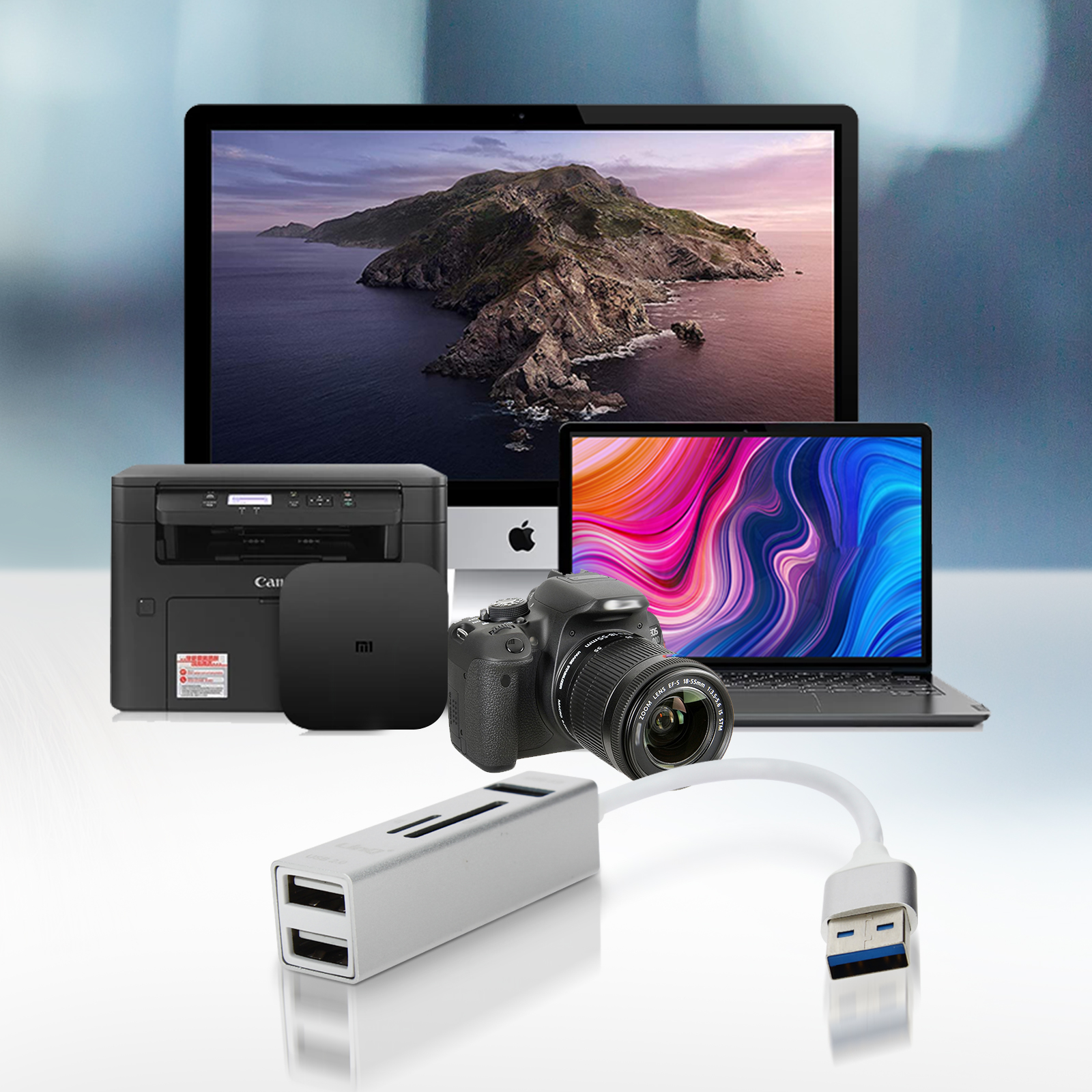Una collezione di dispositivi elettronici tra cui un laptop, monitor, fotocamera, stampante e hub USB.