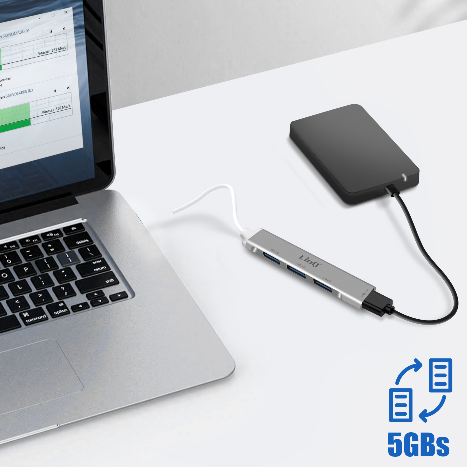 Laptop, hub USB con porte e un disco rigido collegati su una superficie bianca, con icone dati.