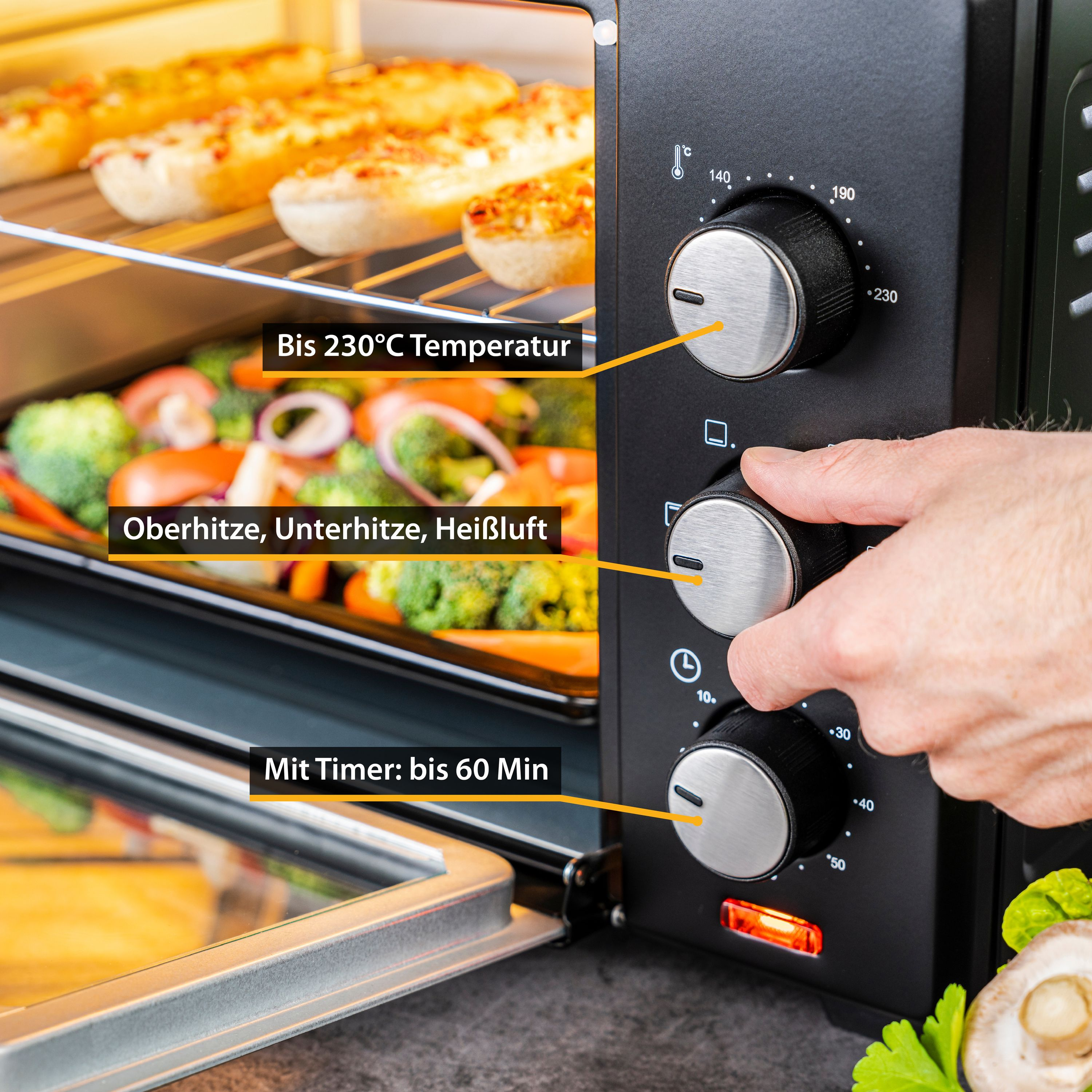 Schwarzer Ofen mit Essen. Knöpfe für Temperatur und Timer sind sichtbar.