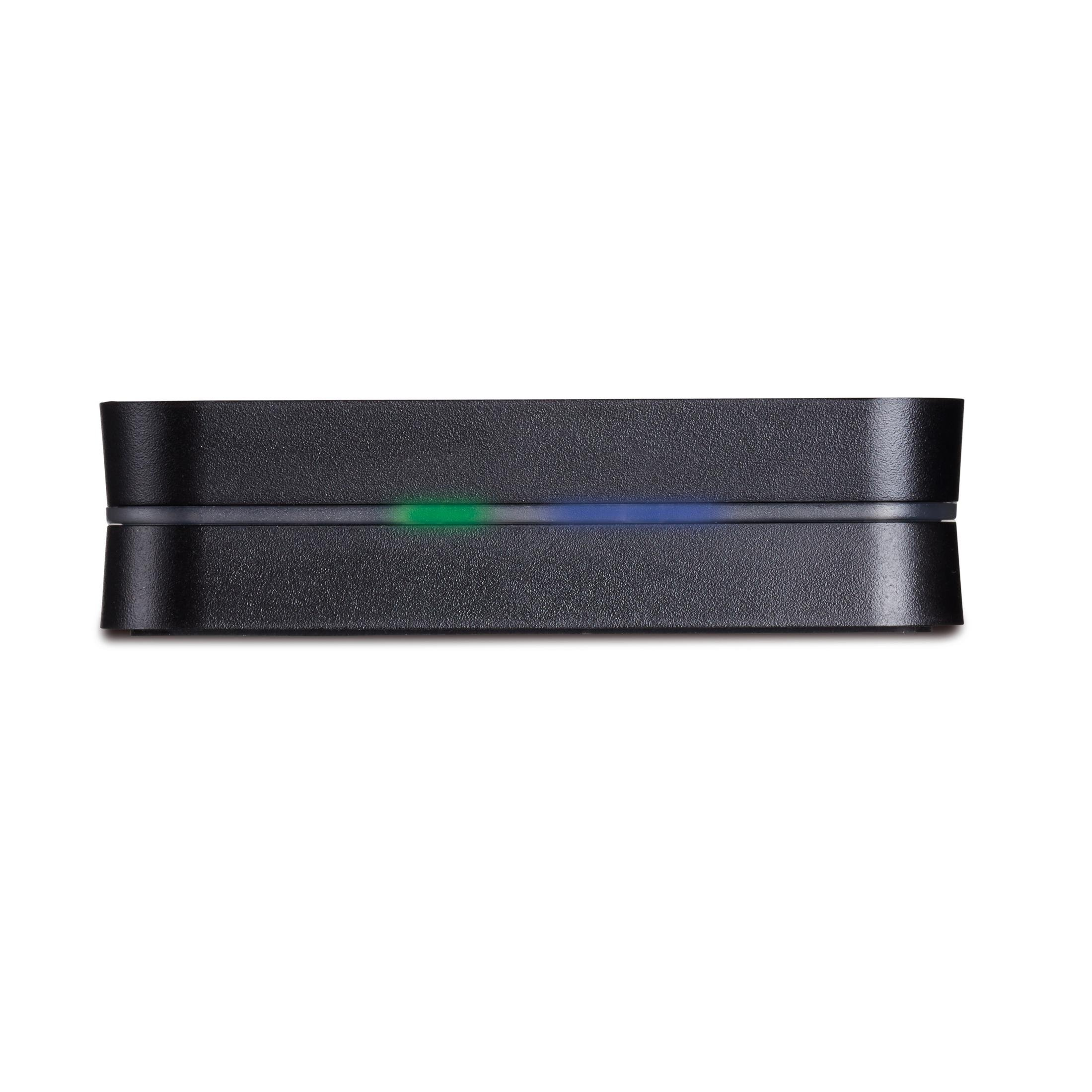 Appareil noir avec une lumière verte et bleue. L'appareil est rectangulaire et sur une surface blanche.
