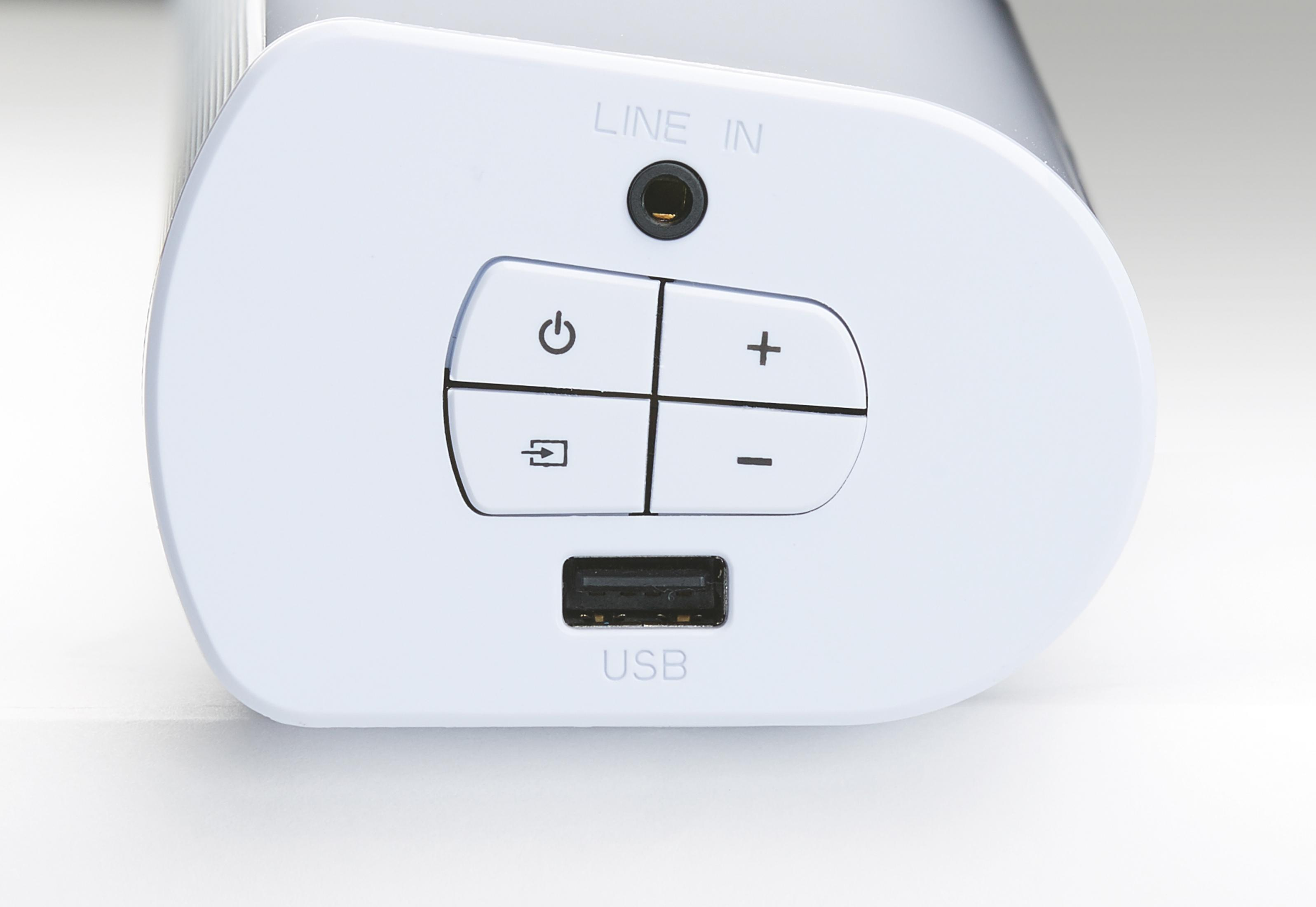 Biały panel sterowania soundbarem z przyciskami. Zawiera port USB, przyciski i wejście liniowe.