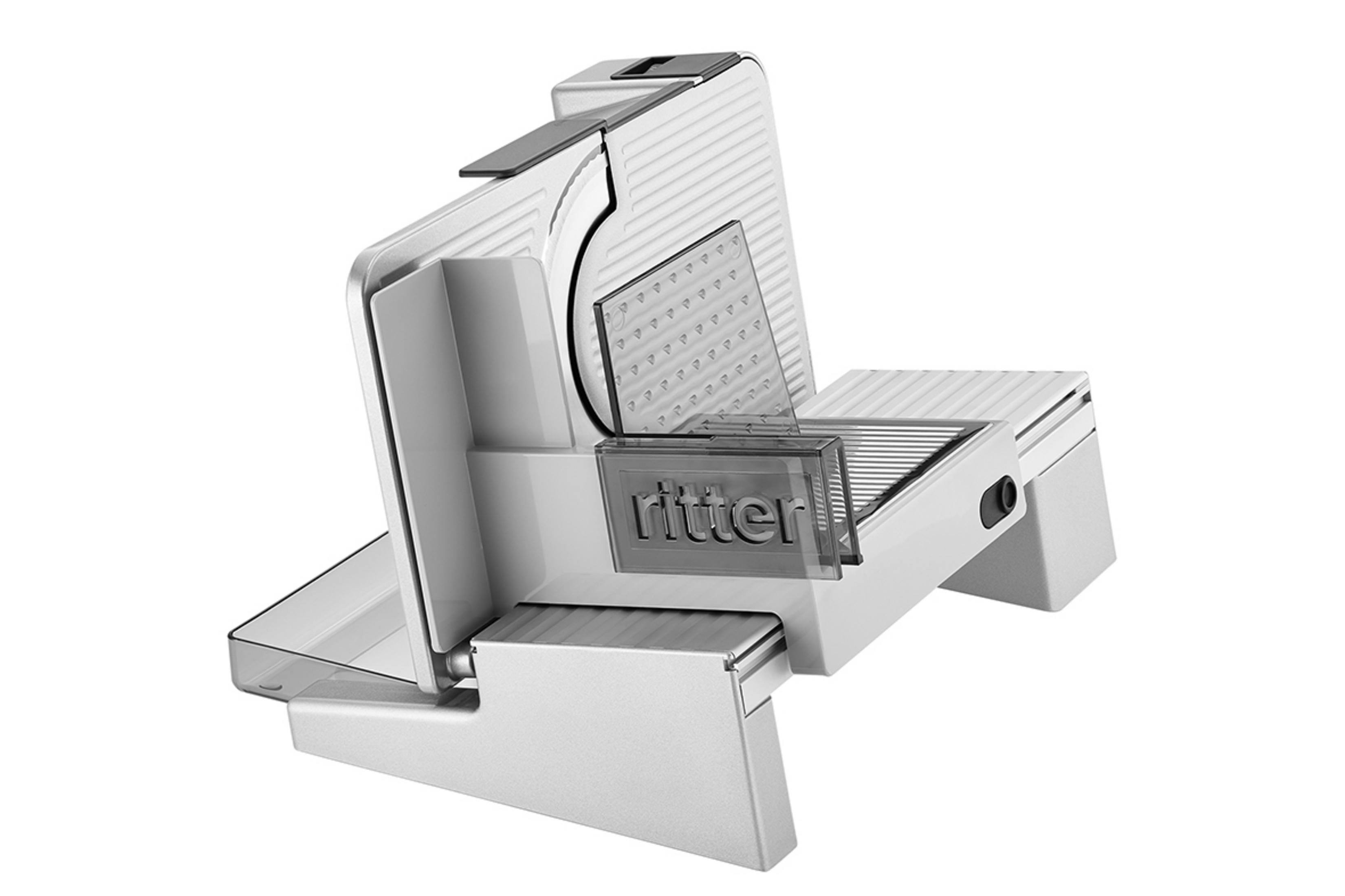 Biała krajalnica do żywności Ritter, widok pod kątem. Posiada przezroczysty prowadnik.