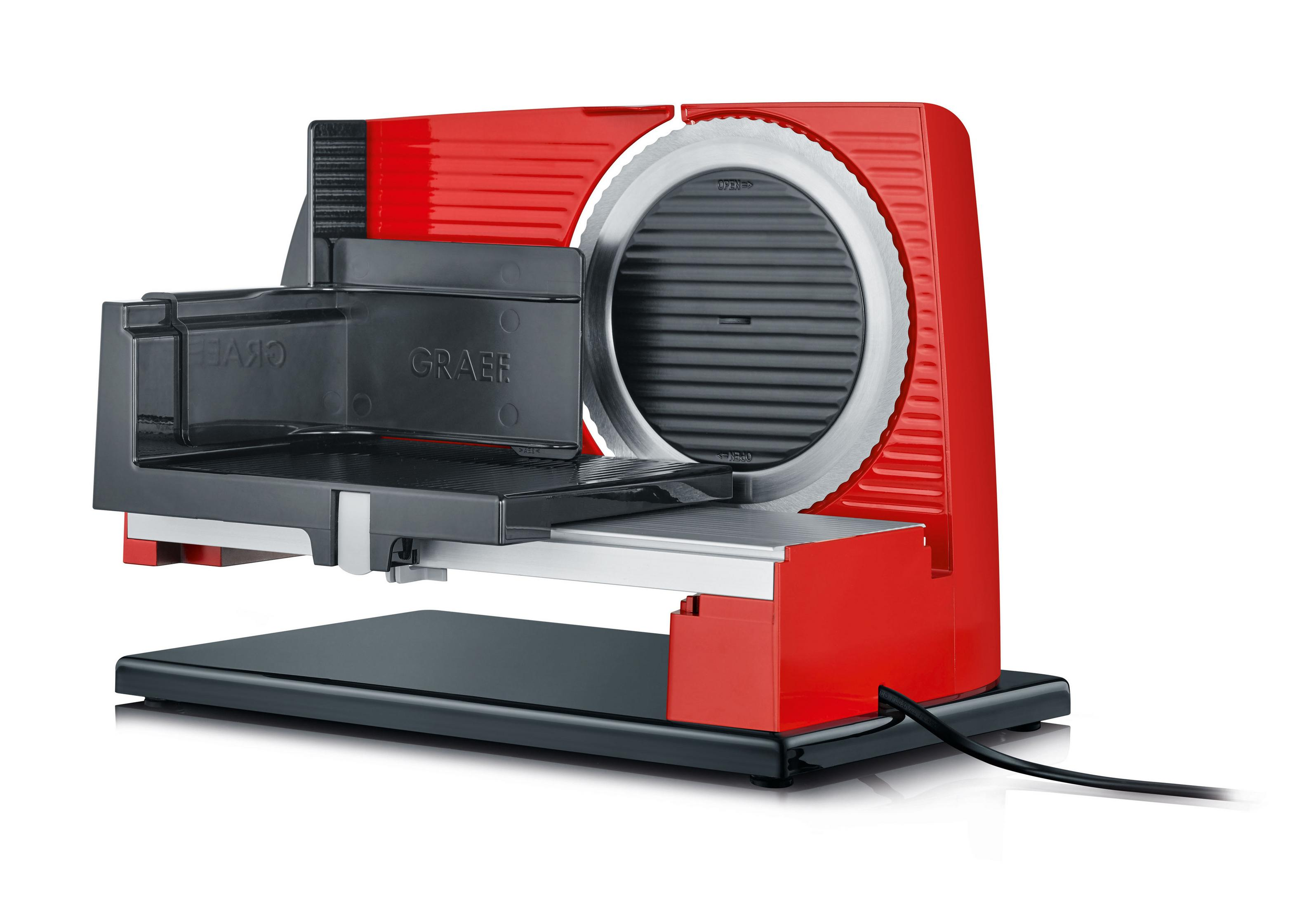 Czerwona i czarna krajalnica do mięsa z ostrzem i plastrem mięsa w trakcie krojenia.