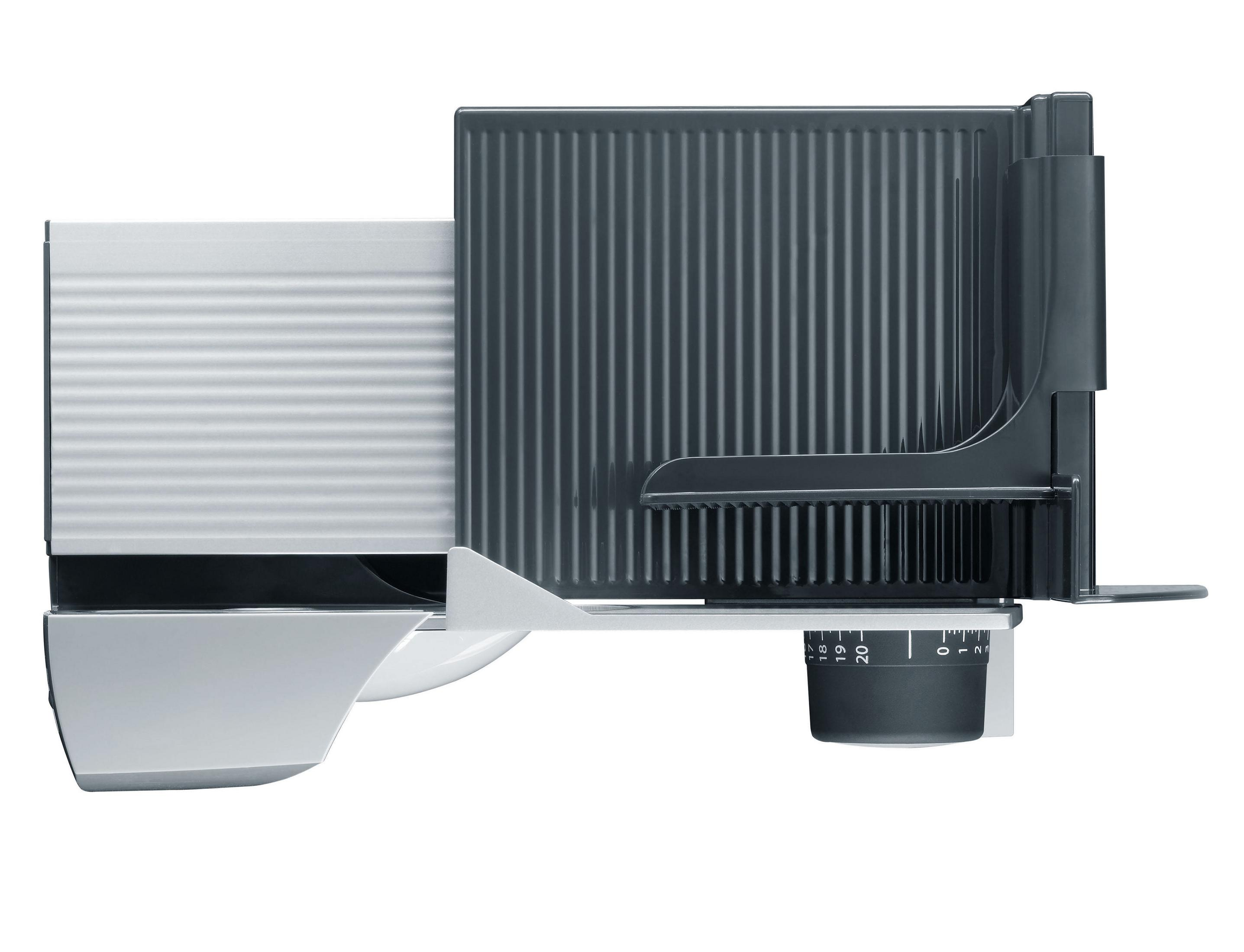 Szara i biała krajalnica do żywności. Krajalnica ma ostrze, wózek na żywność i pokrętło regulacji grubości.