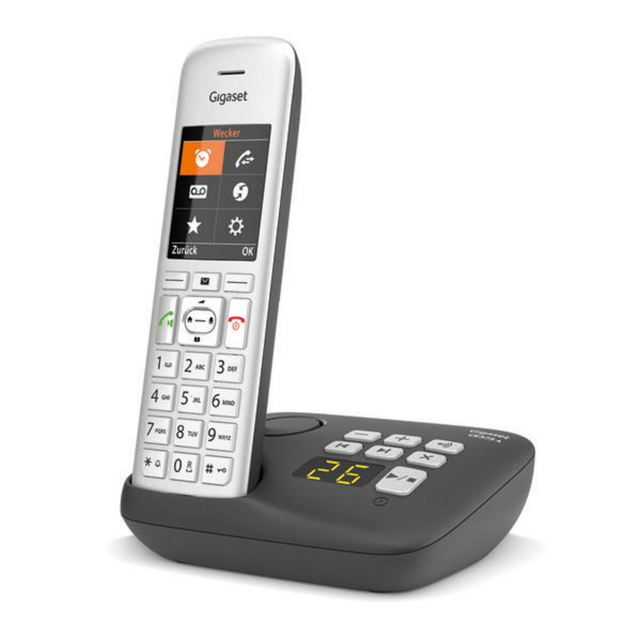 Un telefono fisso bianco con base nera e uno schermo che mostra numeri e simboli.