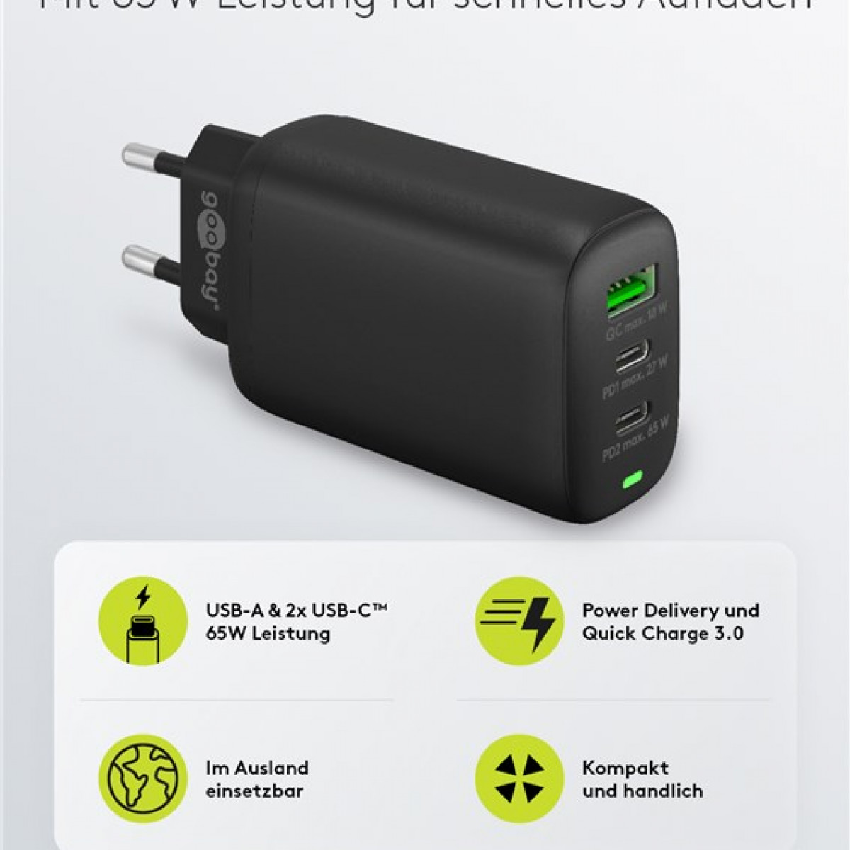 Schwarzer Netzadapter mit mehreren Anschlüssen und Text auf Deutsch. Grüner USB-Anschluss ist sichtbar.
