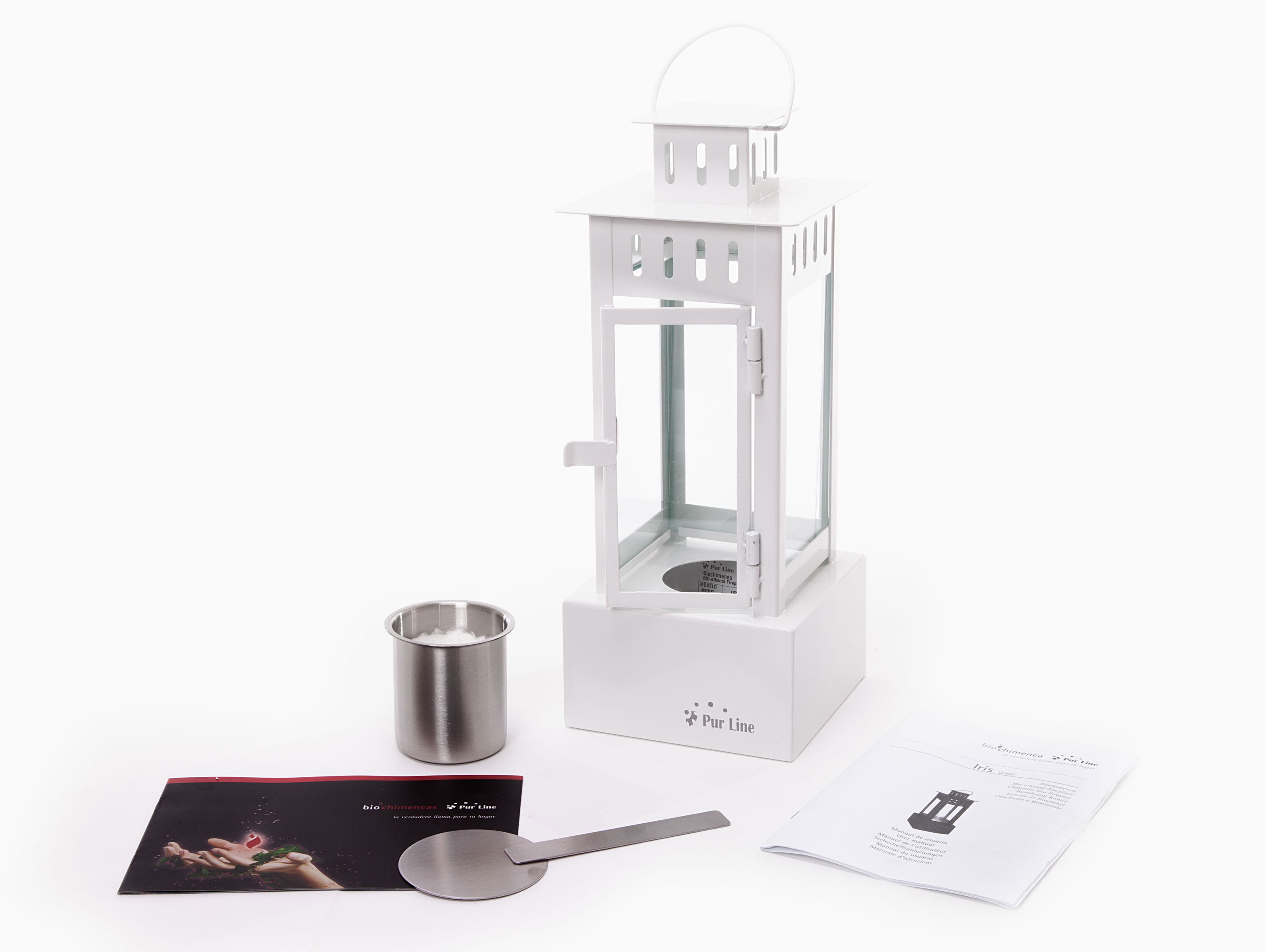 Linterna blanca con vela y accesorios, incluidas instrucciones y una cuchara.