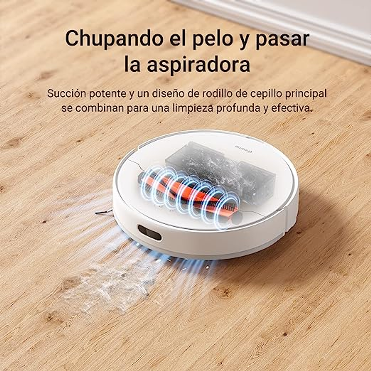 Robot aspirador en suelo de madera. Cepillo rojo en el centro, cuerpo blanco, acción de limpieza visible.