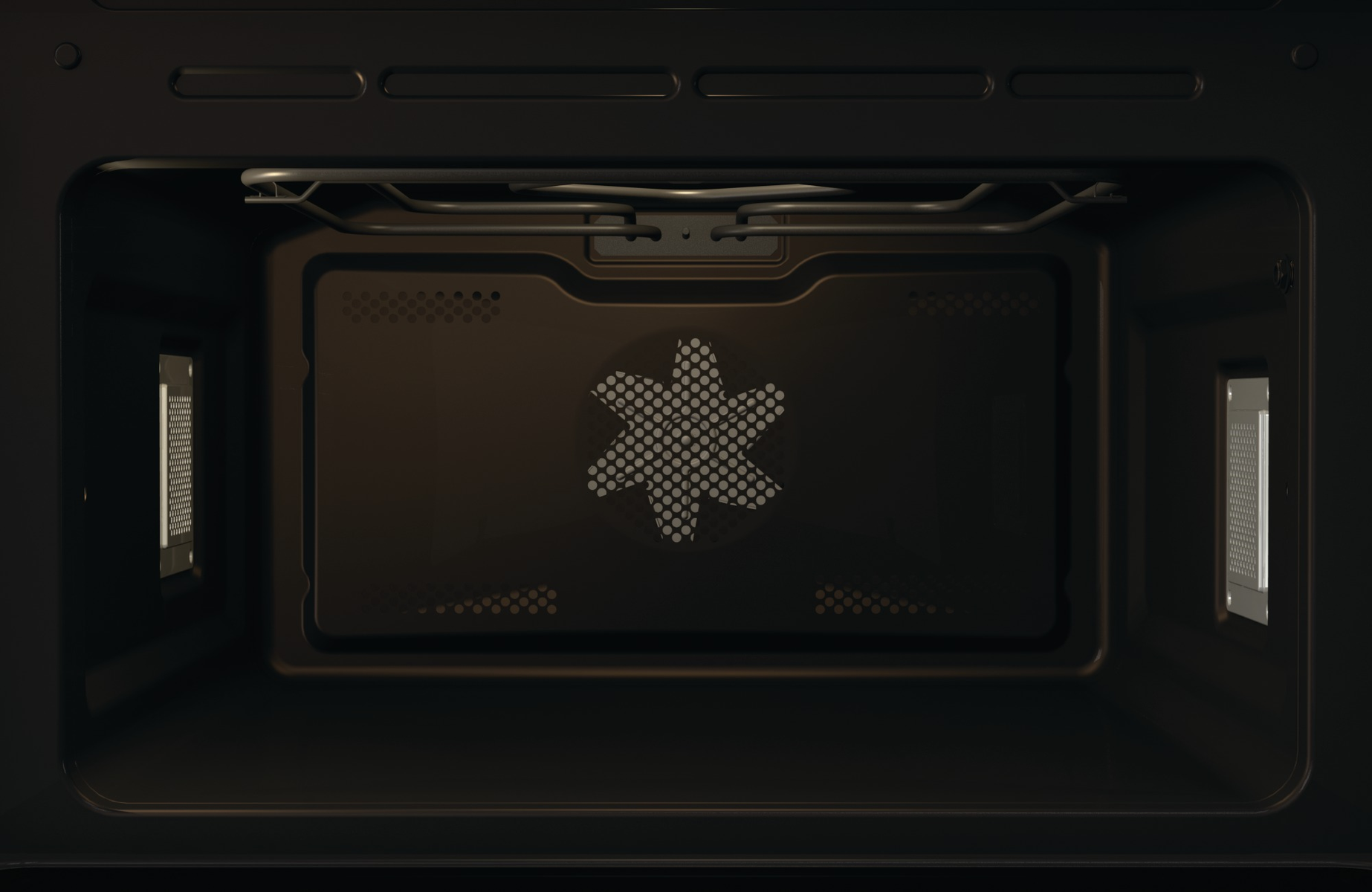 Interno di un forno nero. C'è una ventola sul retro. Il forno è vuoto.