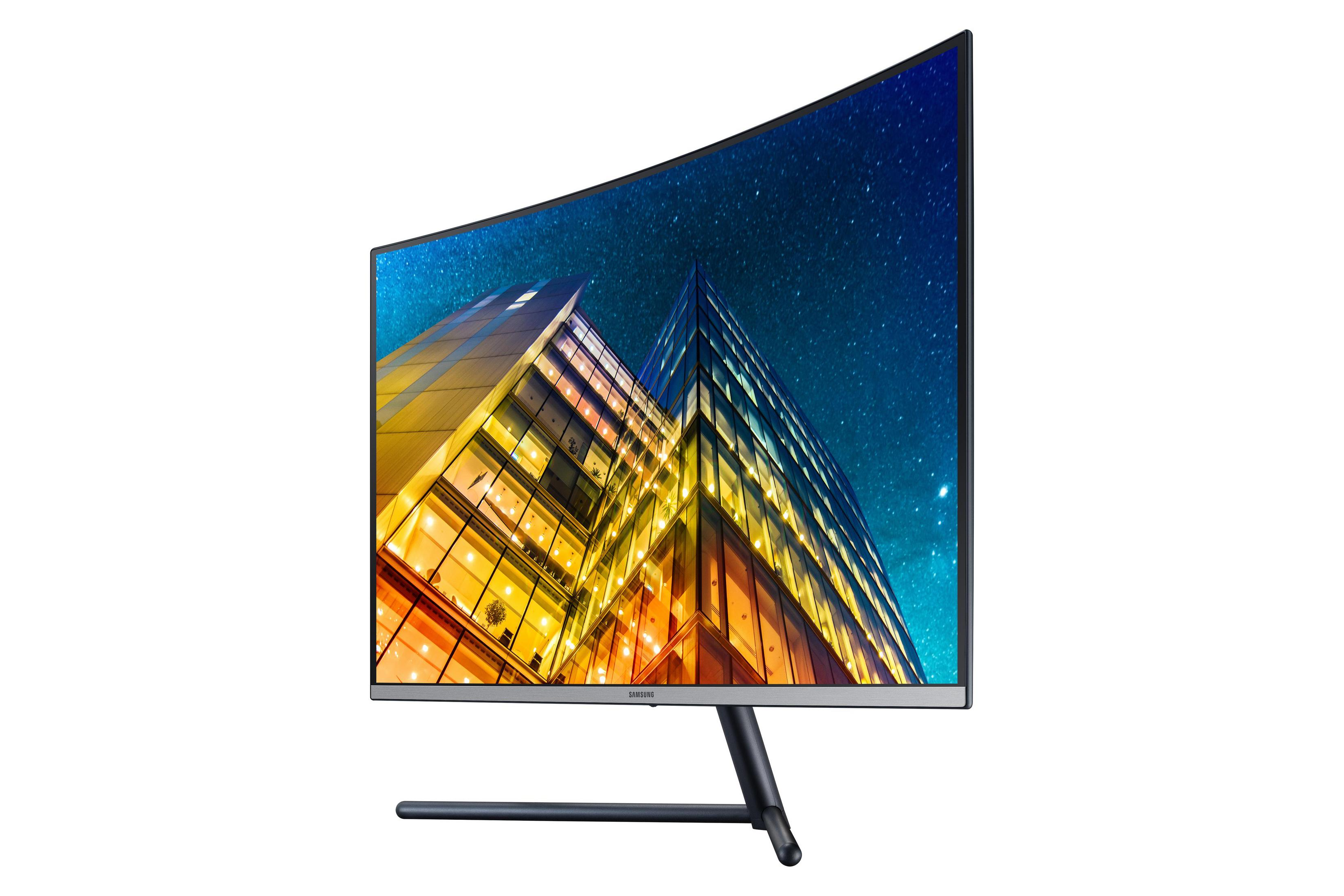 Ein gekrümmter Computermonitor zeigt eine Stadt bei Nacht. Das Samsung-Logo ist sichtbar.