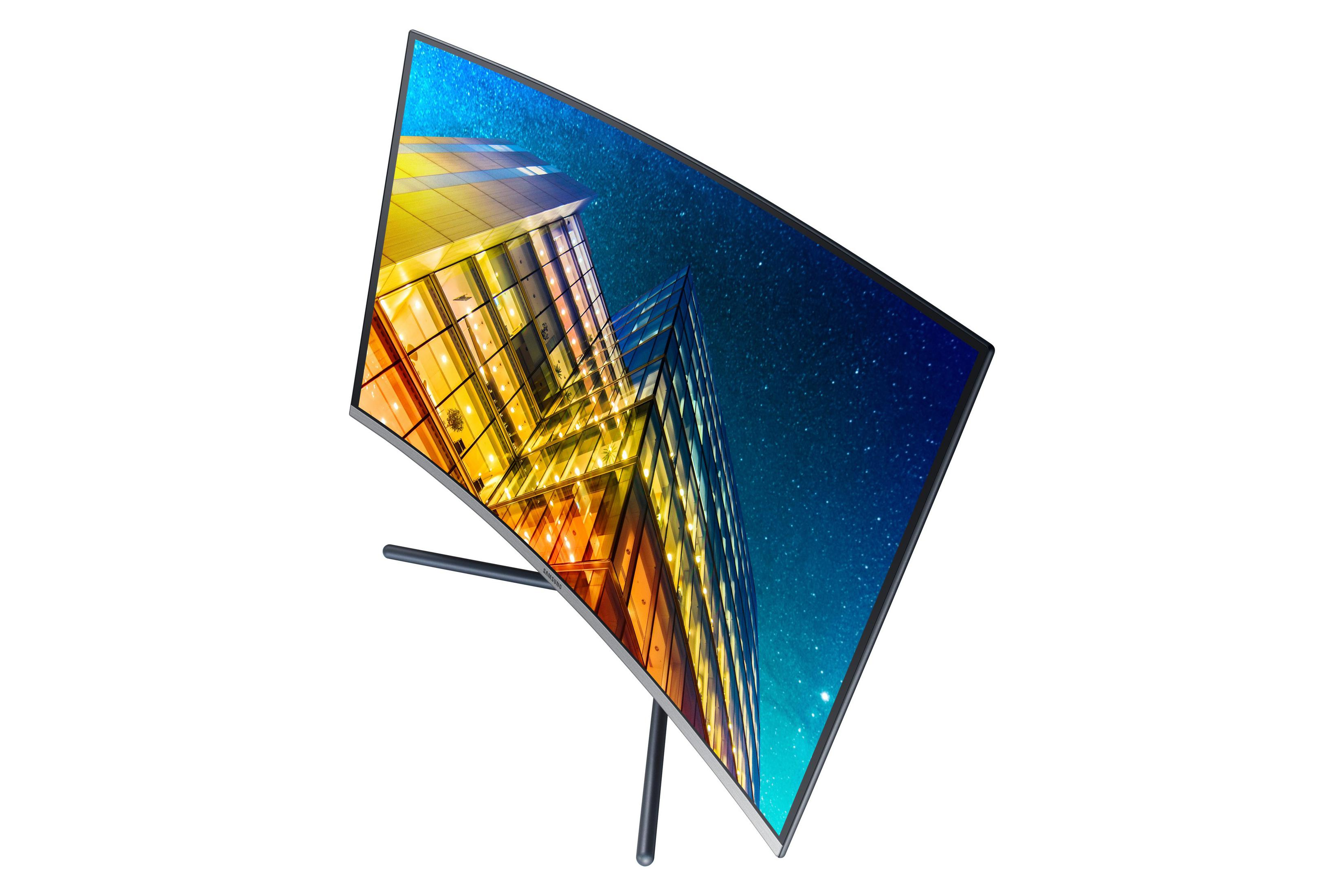 Gebogener Computermonitor, der eine Stadt bei Nacht mit Sternenhimmel zeigt.