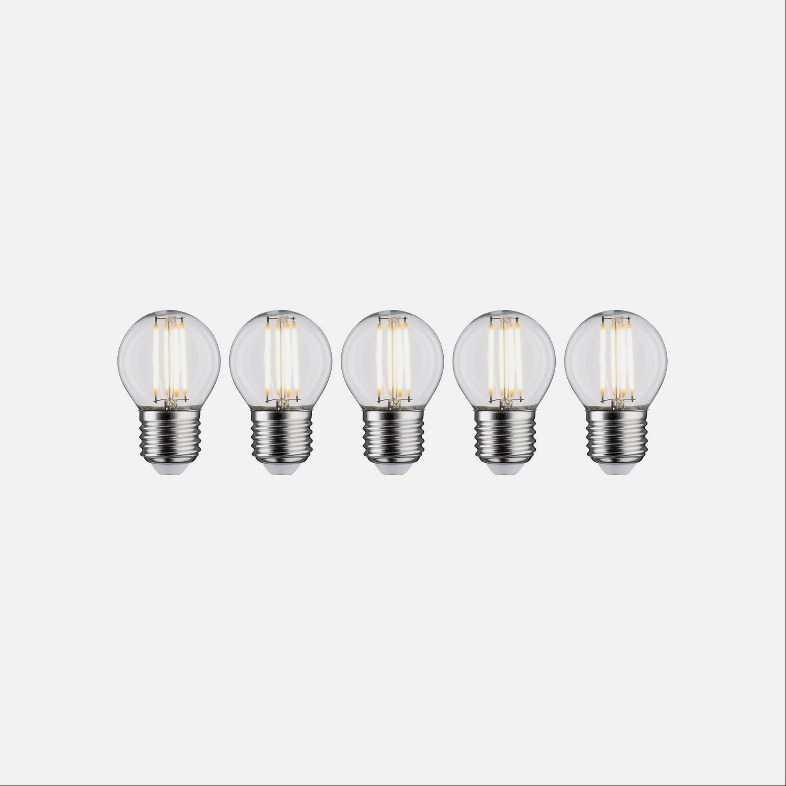 Pięć przezroczystych żarówek z żarnikiem w rzędzie.