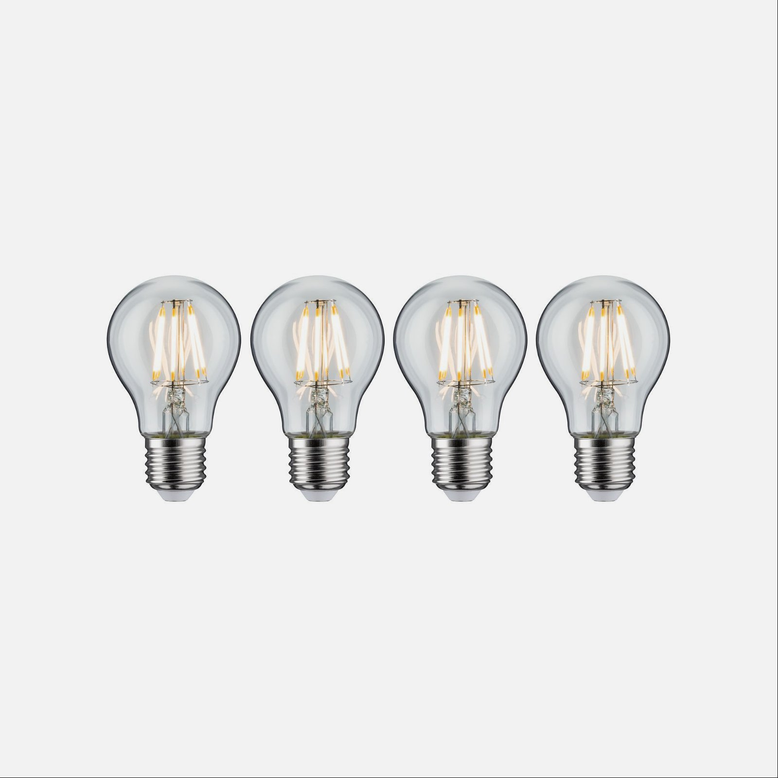 Cztery przezroczyste szklane żarówki ze złotymi włóknami. Żarówki mają srebrne podstawy i są na białym tle.