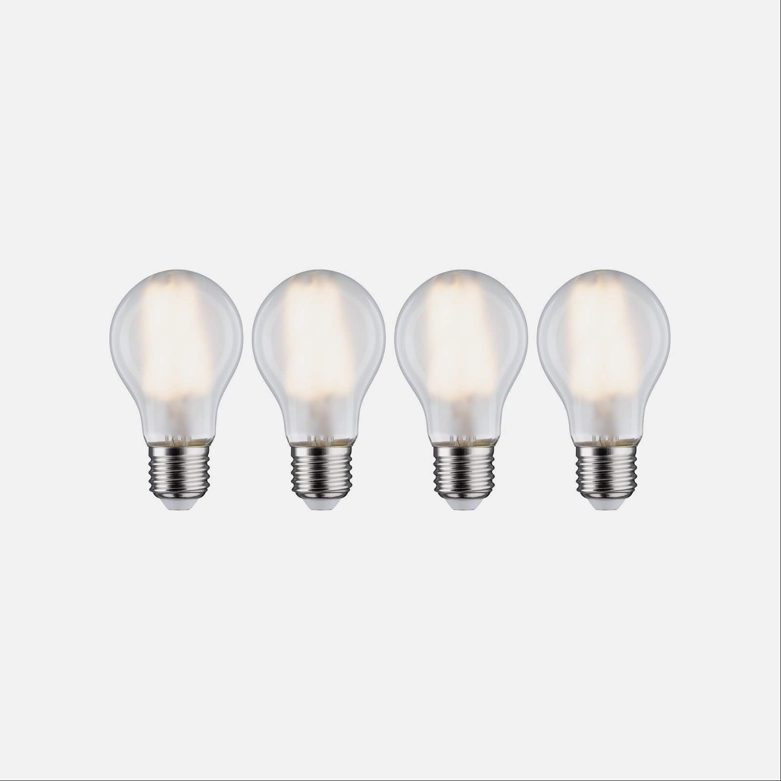 Cztery świecące żarówki na białym tle.