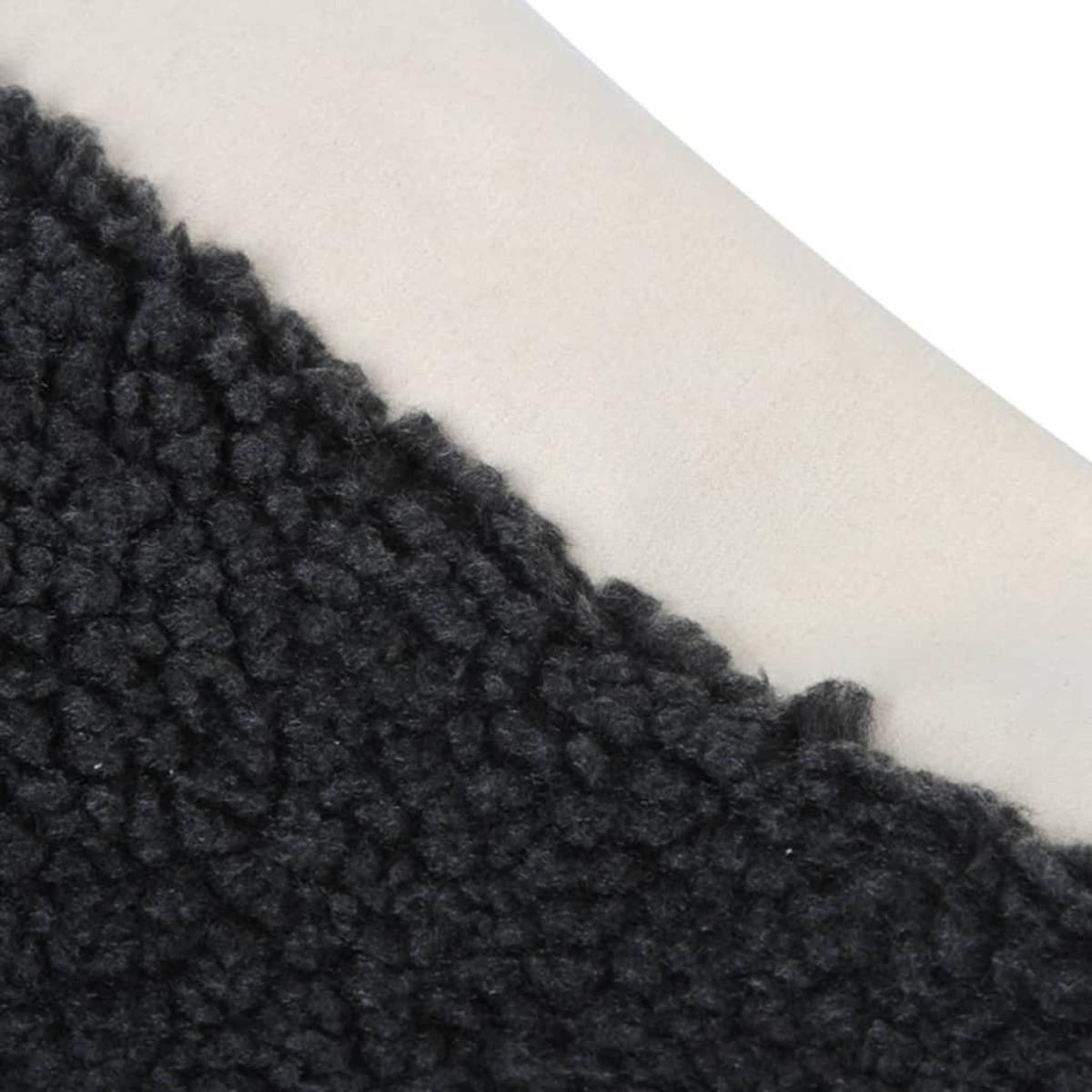 Tessuto bianco e nero. Il tessuto nero è strutturato. Il tessuto bianco è liscio.