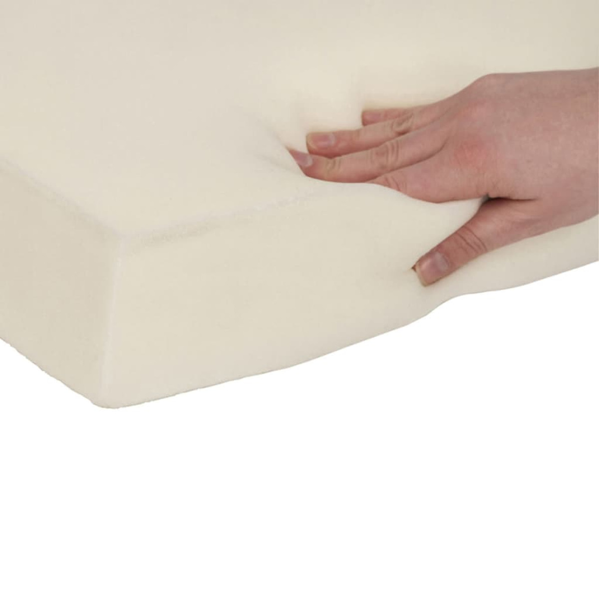 Eine Hand drückt in einen weichen, weißen Schaumstoffblock.