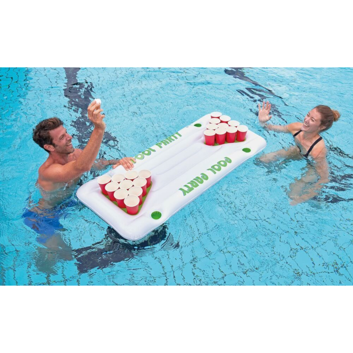 Leute spielen Beer Pong in einem Pool, rote Becher auf einer schwimmenden Plattform.